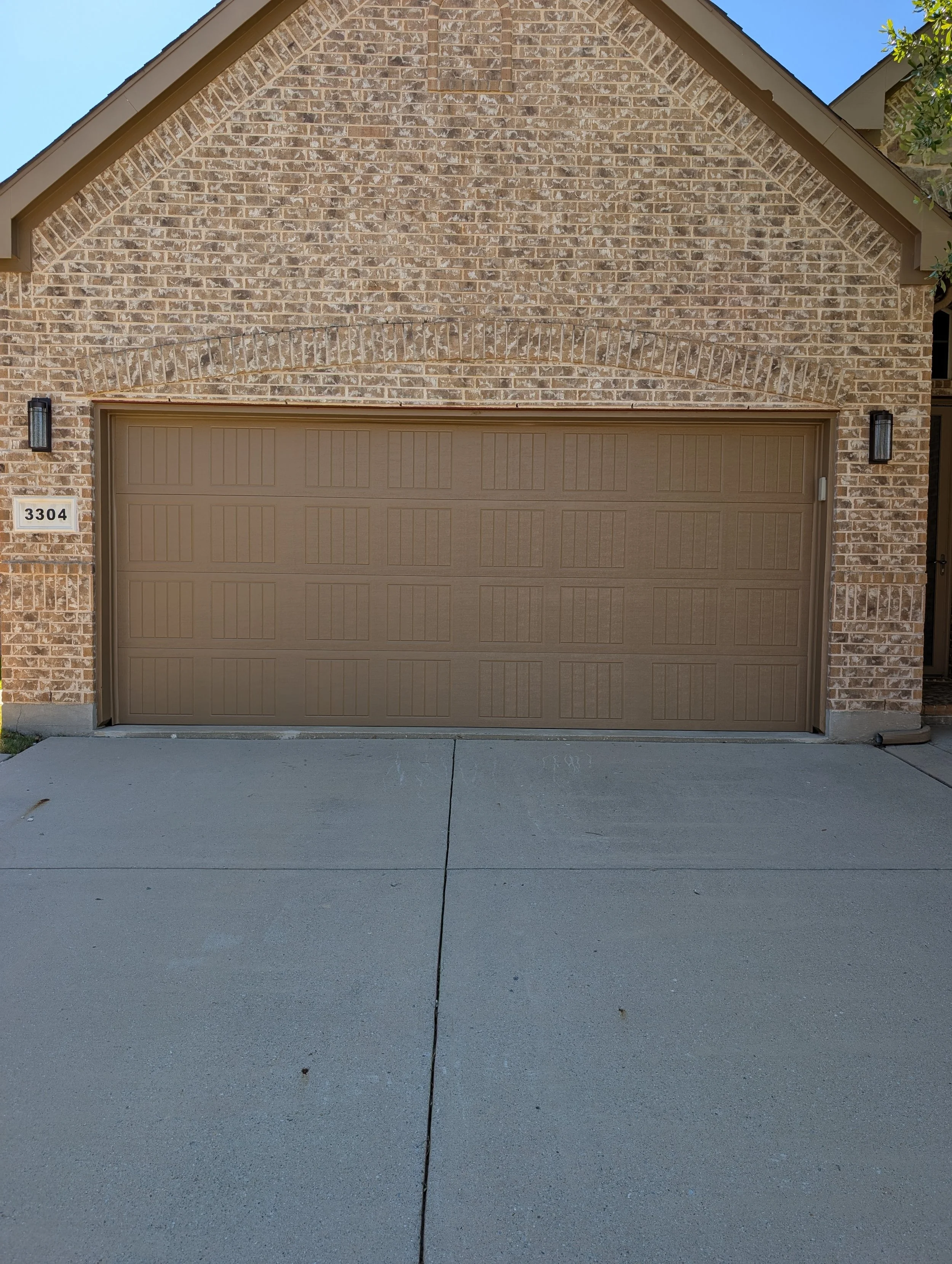 Painting of a garage door and trim in Denton, TX - After