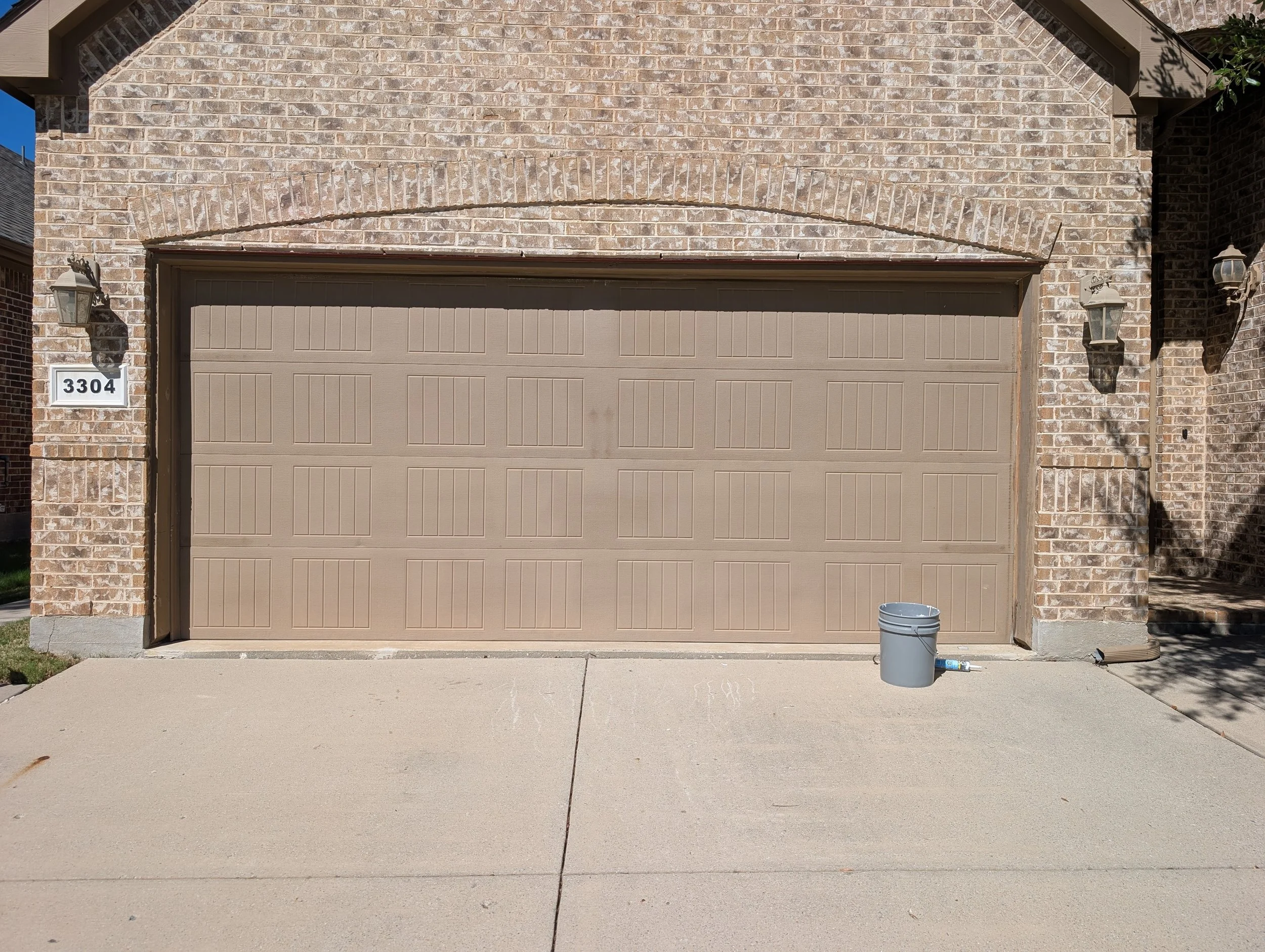 Painting of a garage door and trim in Denton, TX - Before