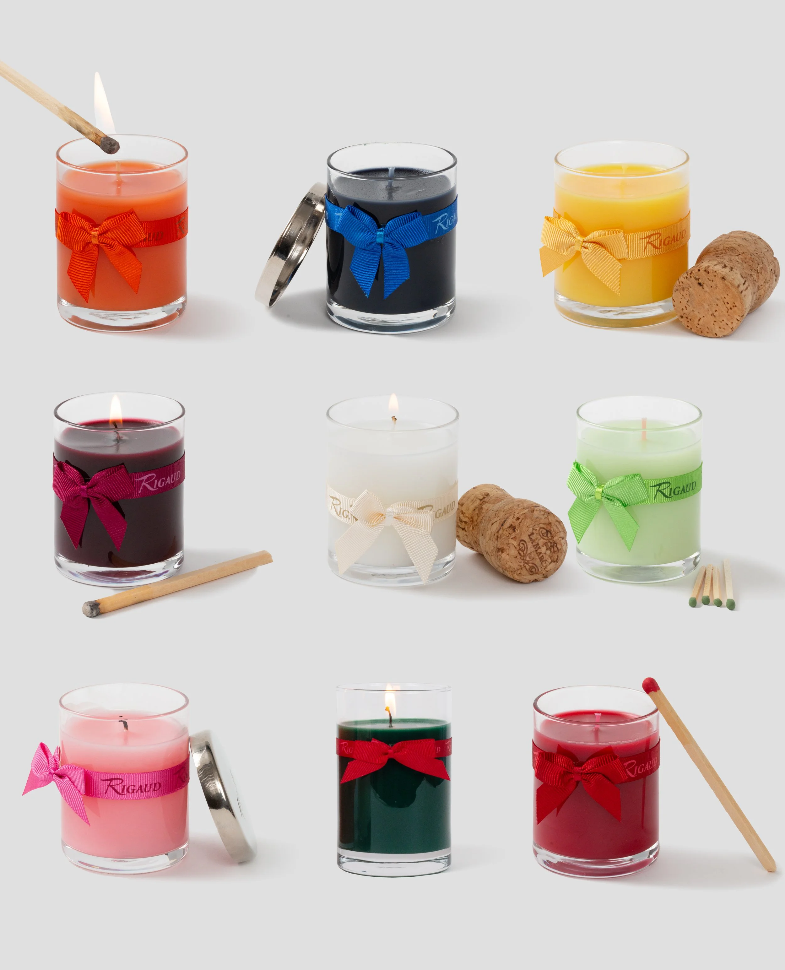 Nine glass candle votives arranged in three row, each wrapped with bright, colorful bows.