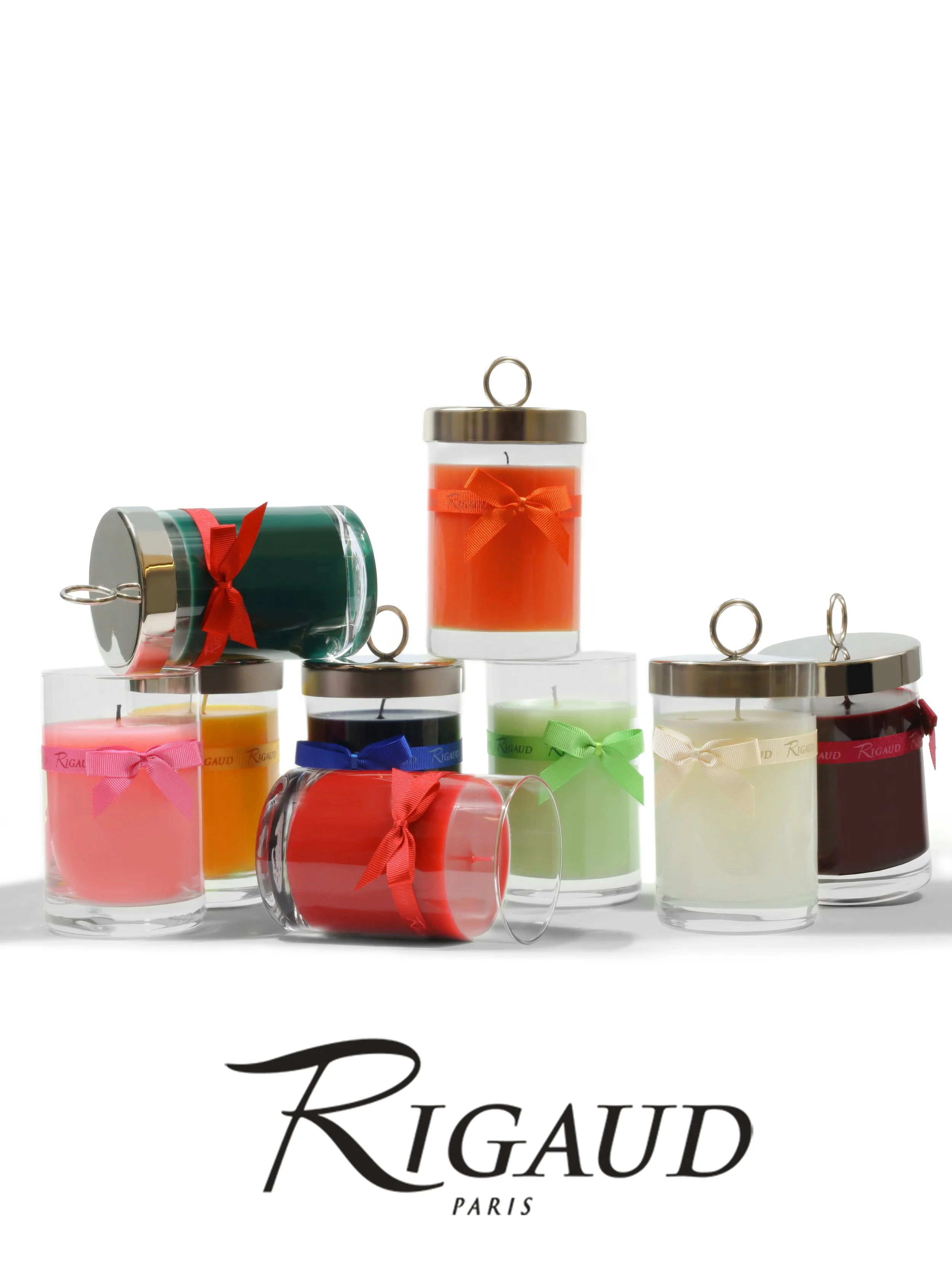 Nine glass candle votives arranged in a staggered row, each wrapped with bright, colorful bows.