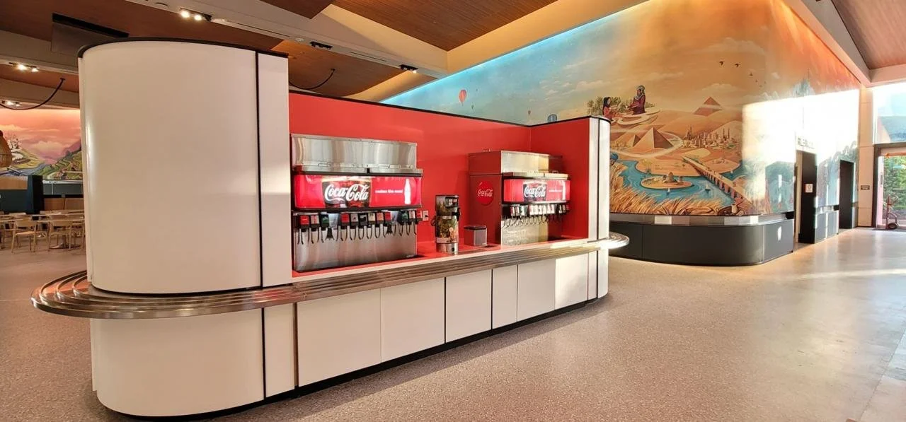 Beverage station at the EPCOT food court featuring Corian® solid-surface installation, architectural metal components, and custom millwork by Metric Smart Solutions. Scope included precision fabrication, on-site assembly, and high-traffic commercial