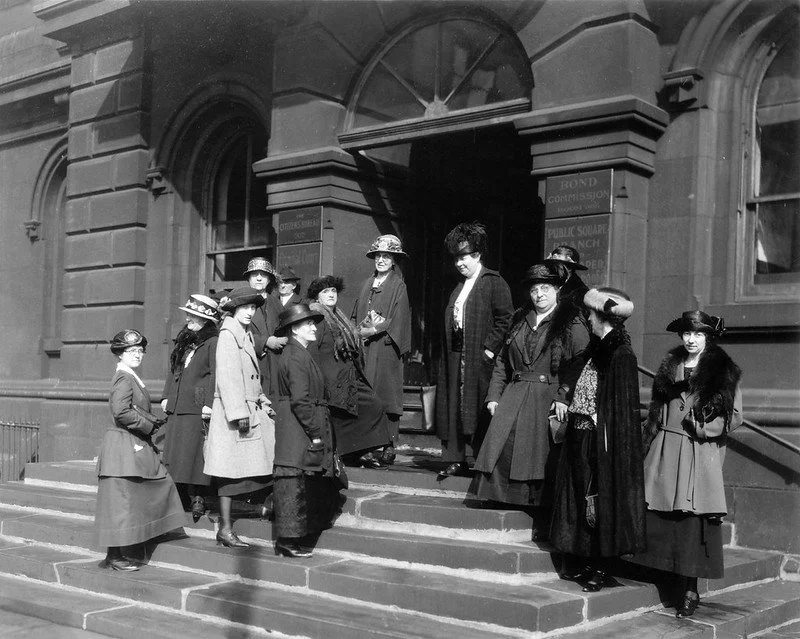Miss. Belle Sherwin (center, wearing plaid coast, hat with feather) and other women members down from jury panel to hear civil and commercial cases in Cleveland, Ohio Court in late February of 1923. Picture taken on steps of old court house in Clevel