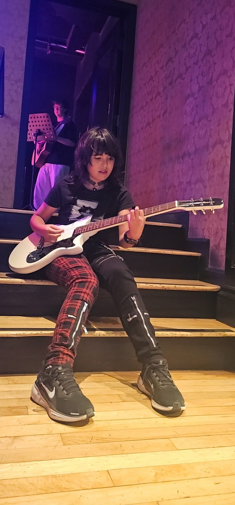 Female punk, rock, and emo artist, Morgan Emslie preparing to sing and play the electric guitar at the Sweetwater in Mill Valley, California. Morgan performs as @Amped2Howl
