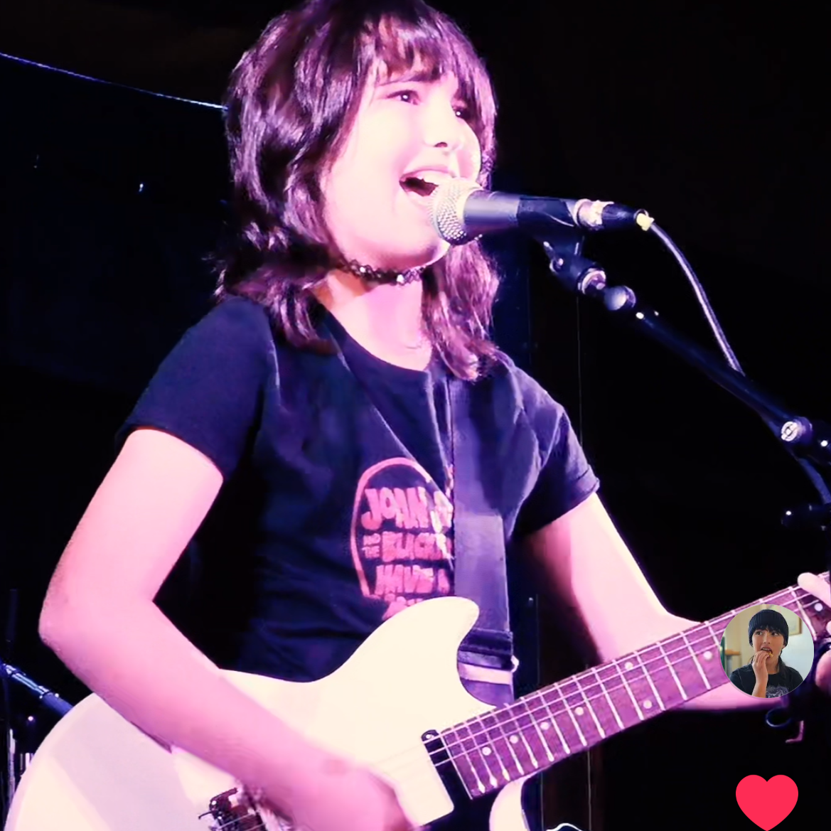 12 year old girl, Morgan Emslie, sings alt-rock, emo songs while playing the electric guitar on stage. She is singing What's Up by 4nonBlondes. Influences include Paramore, Green Day, Joan Jett and Good Charlotte. Morgan sings under Amped2Howl.