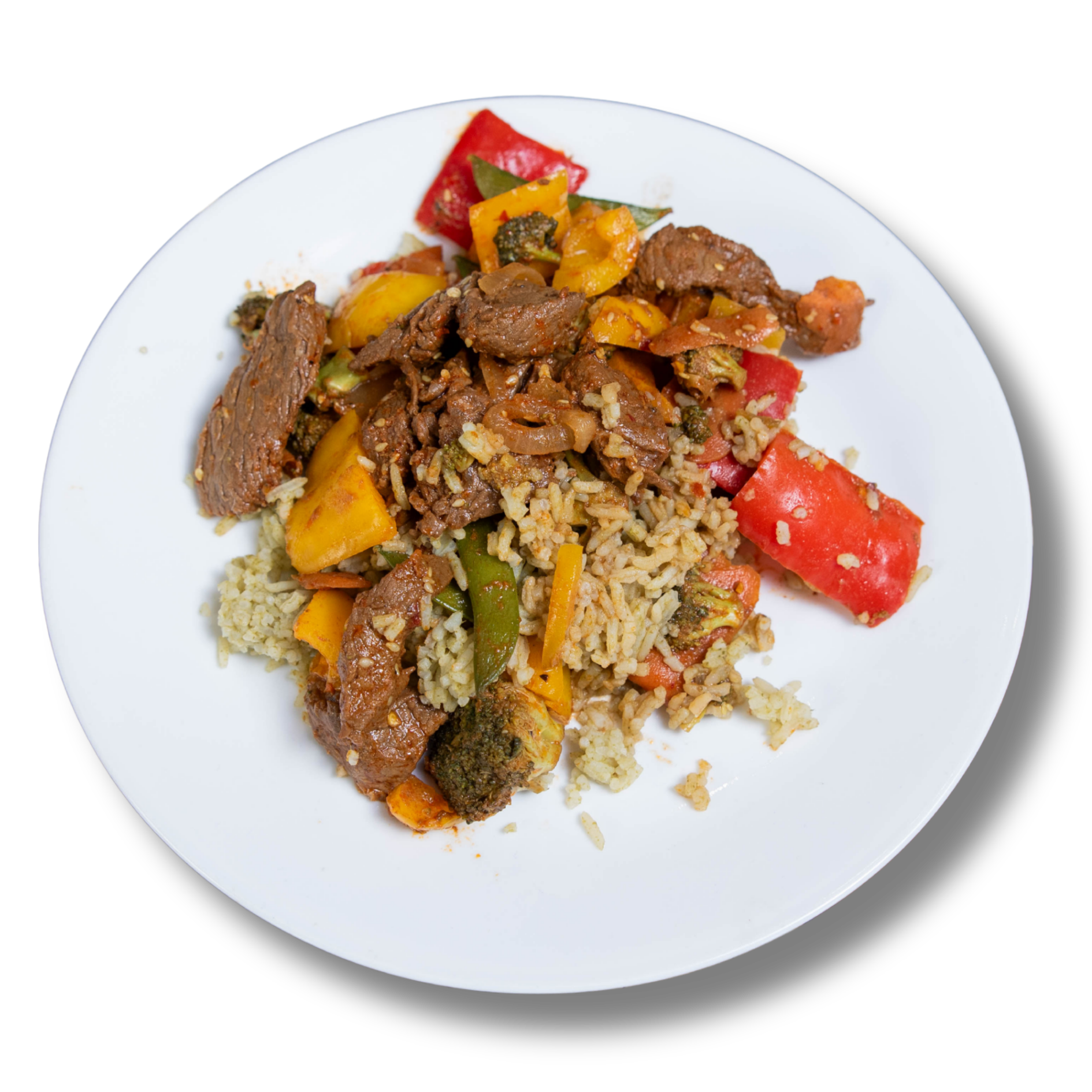 Plate of stir-fried beef with mixed vegetables served over seasoned rice on a white plate
