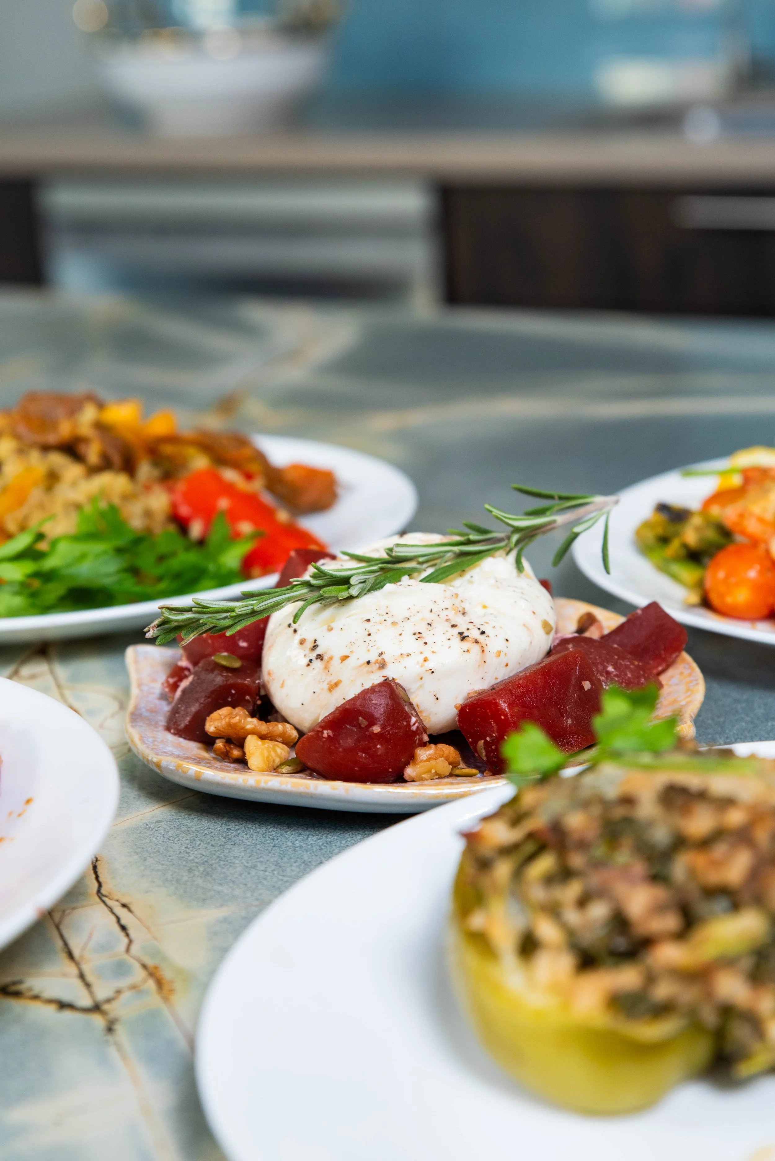 Image of 4 plates of food on table in kitchen