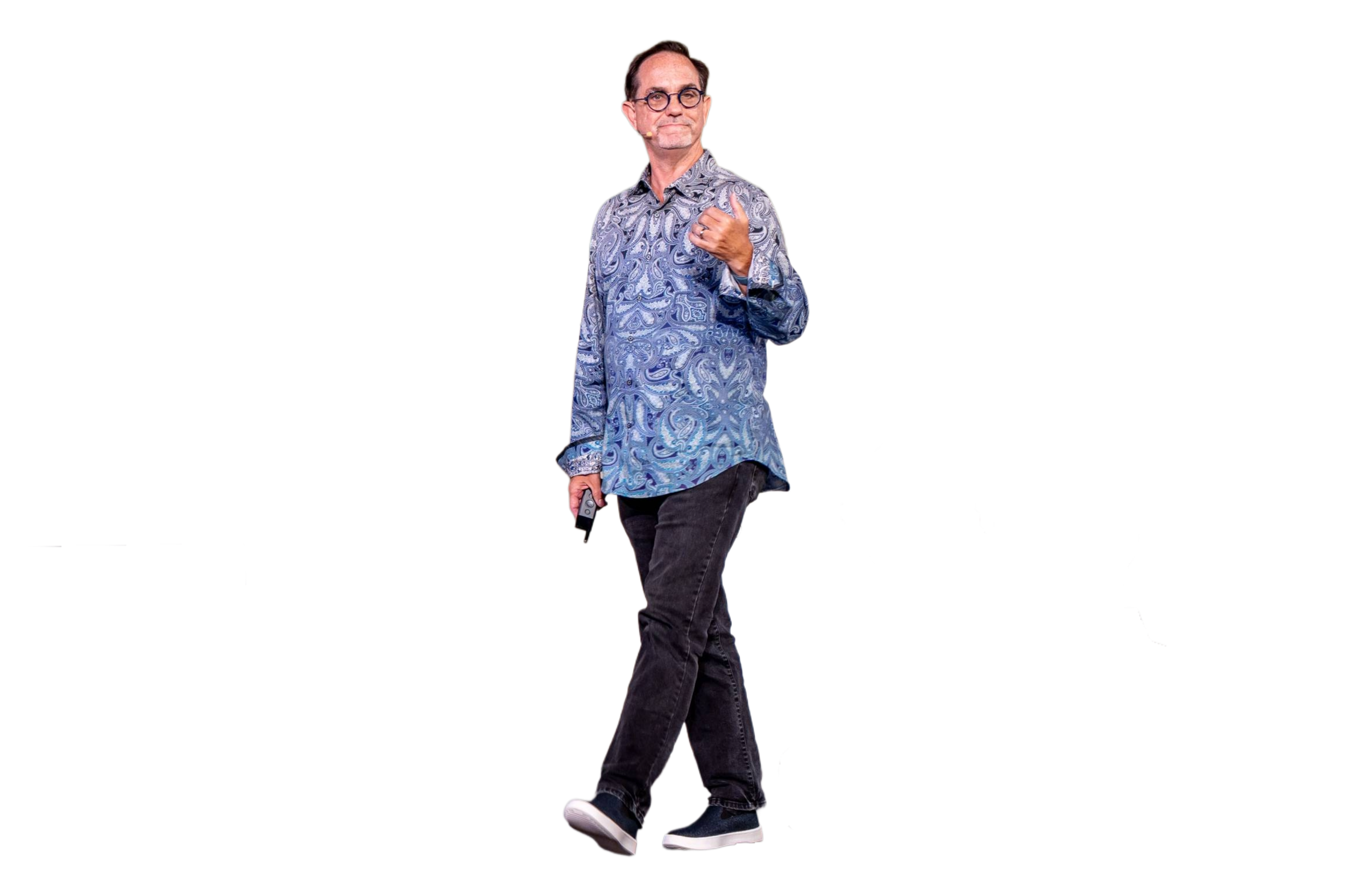 Man with glasses in a patterned blue shirt walking while holding a phone, with a colorful, abstract digital background.