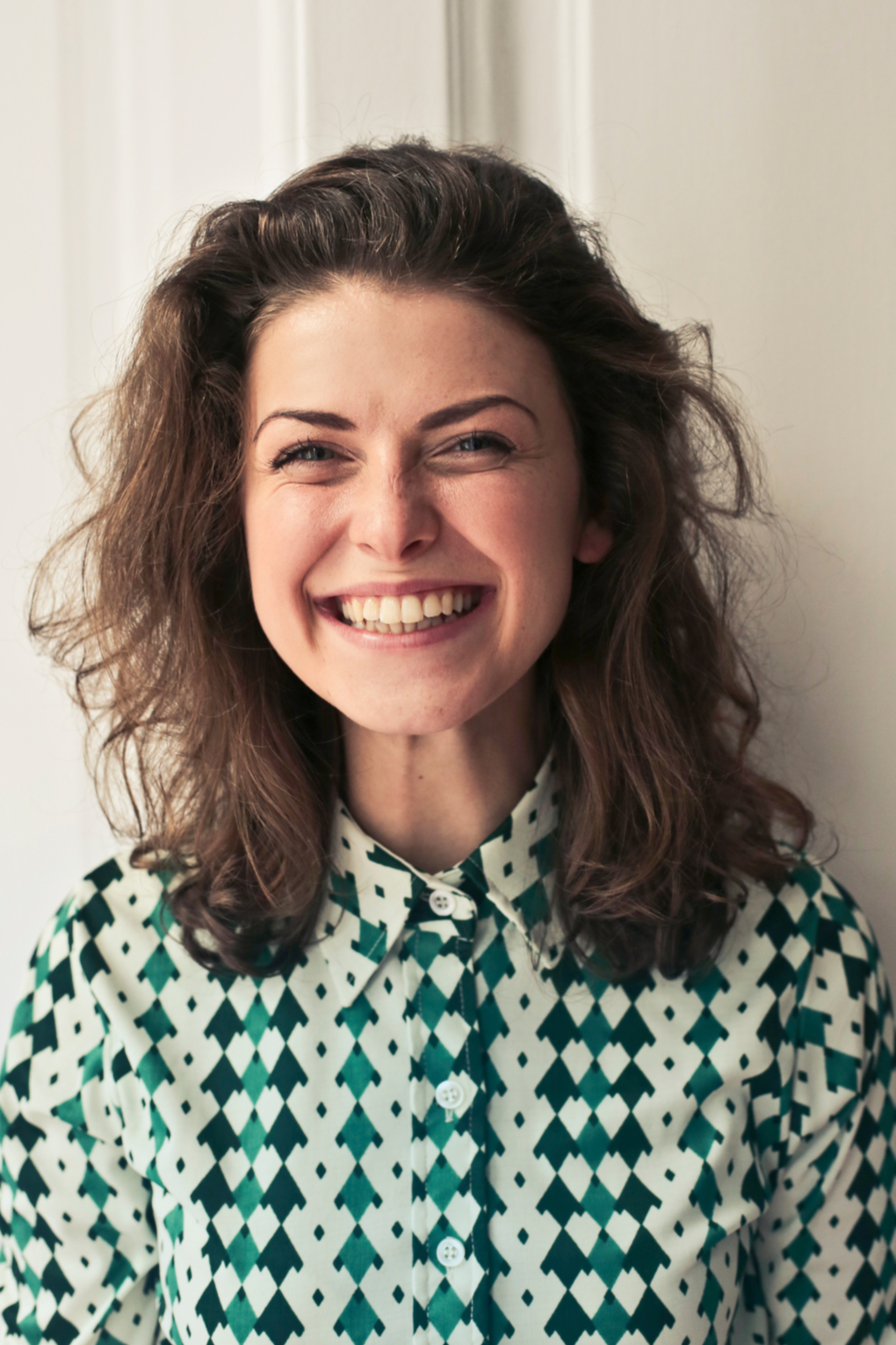 Woman laughing authentically after investing in anxiety therapy with Fresh Therapy LLC.