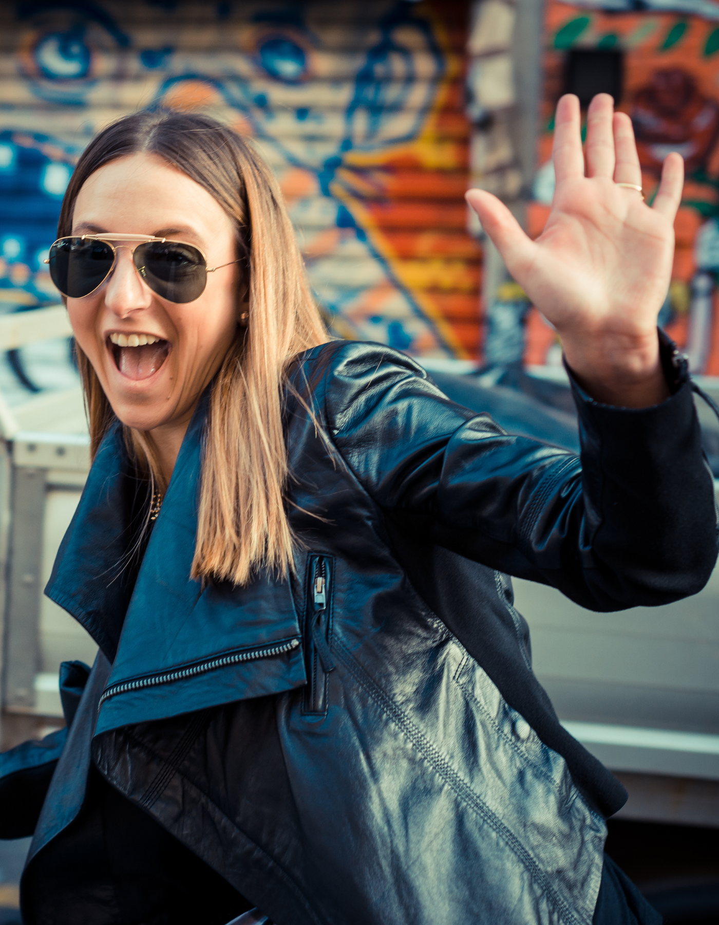 Happy women waving goodbye with luggage in tow after attending anxiety therapy.