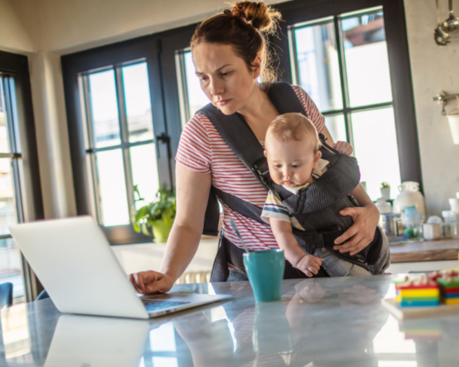 Mom reading Fresh Therapy Blog post while parenting baby in carrier and making time for coffee in the morning.