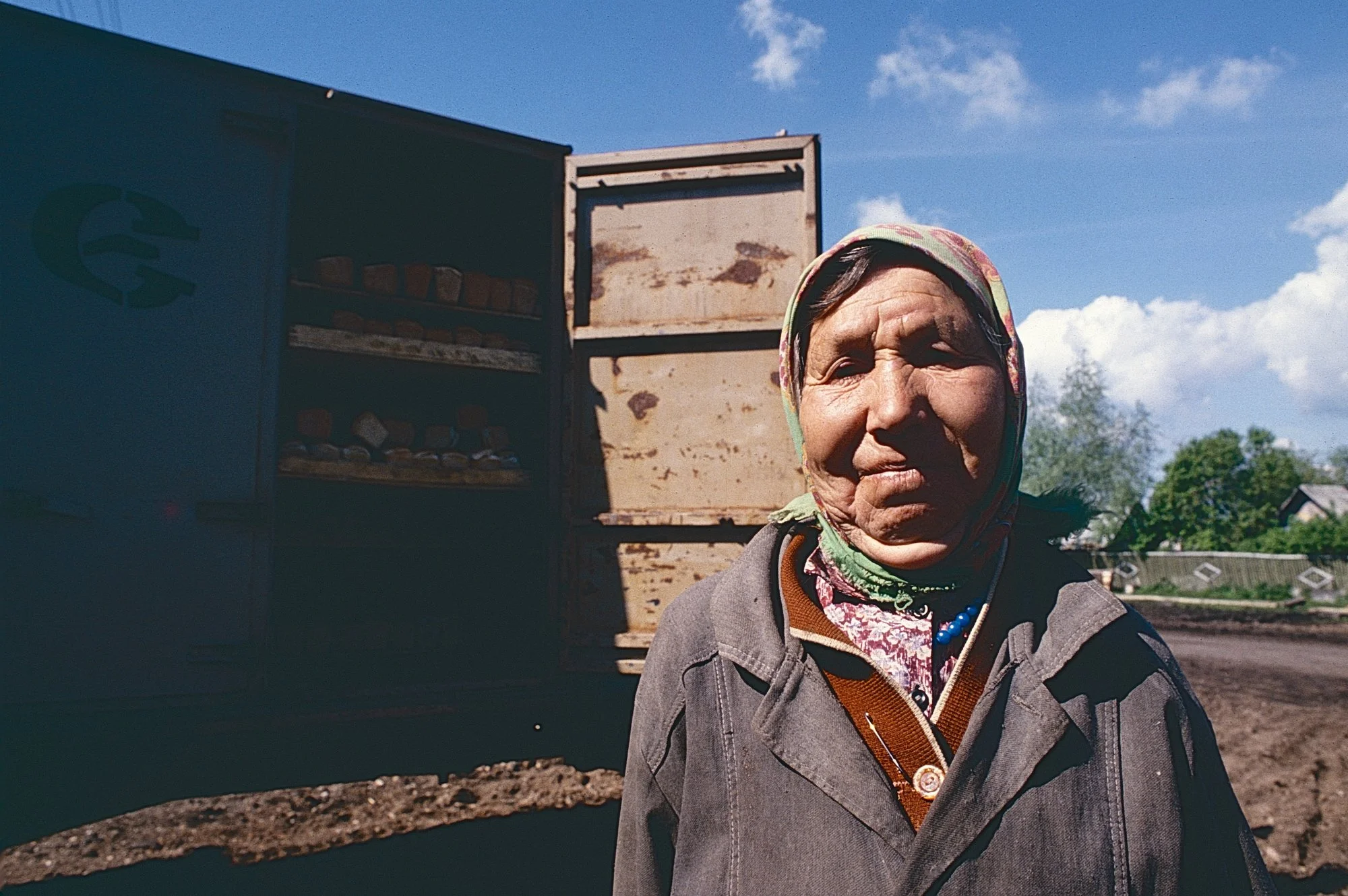 A woman near a bread truck.