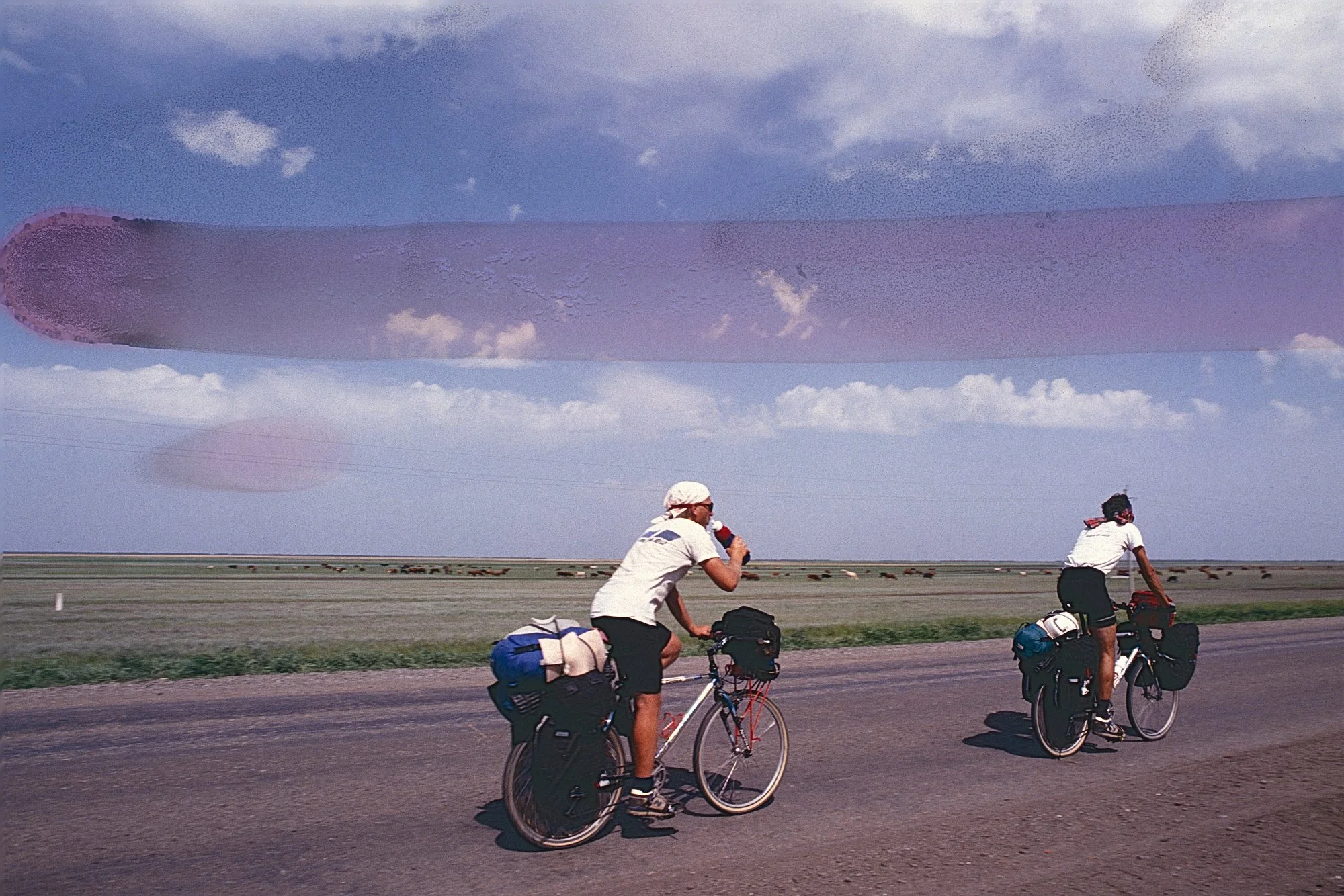 Back on the Russian plains, we battle endless mind numbing straight roads, summer heat, boredom, and constant seasonal headwinds for three straight weeks. Like crossing Kansas seven times, with bad food. 