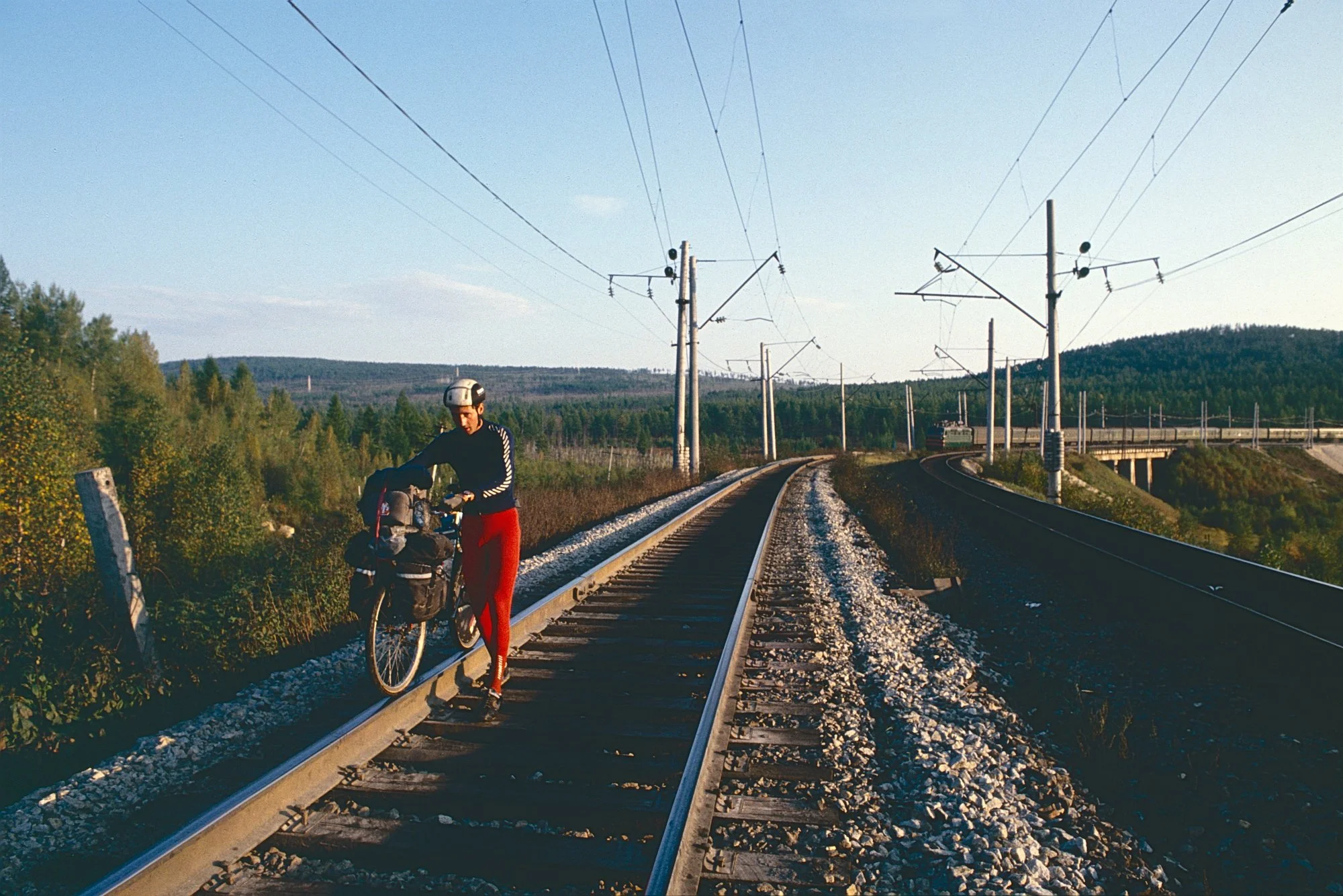 When the swamp becomes impassable, we climb on the Trans-Siberian railroad tracks, and push the bikes. 