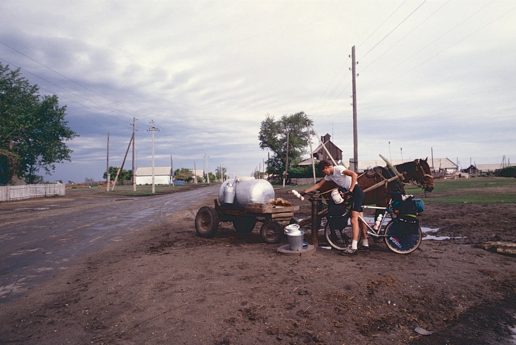 Fetching water at a road side pump in the Russian plains.