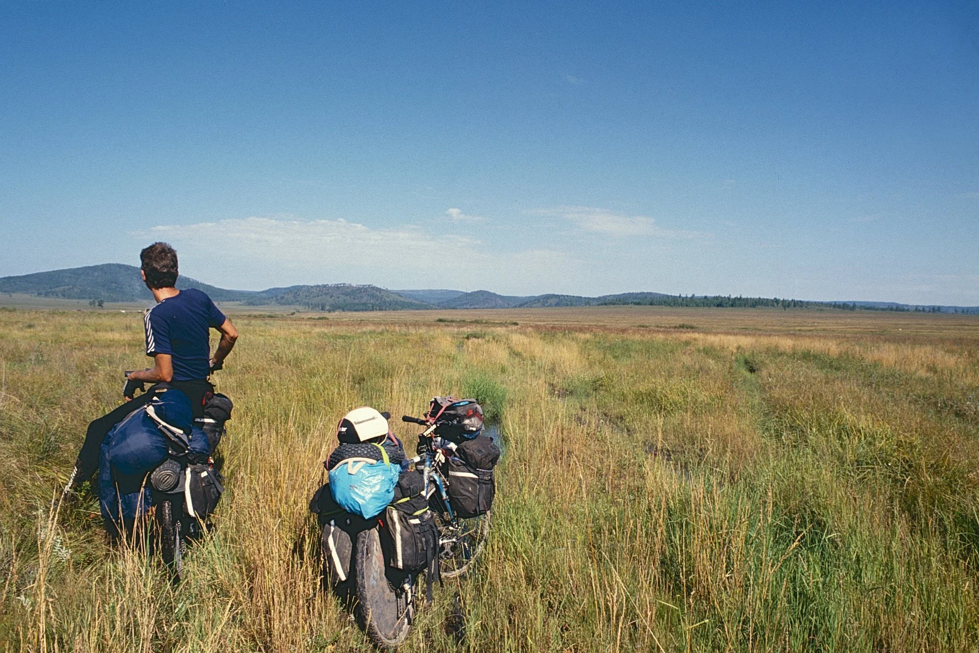 End of the road. Ahead is an 800 kms permafrost water clogged swamp with hungry mosquitoes that bite us through our cycling shoes. 