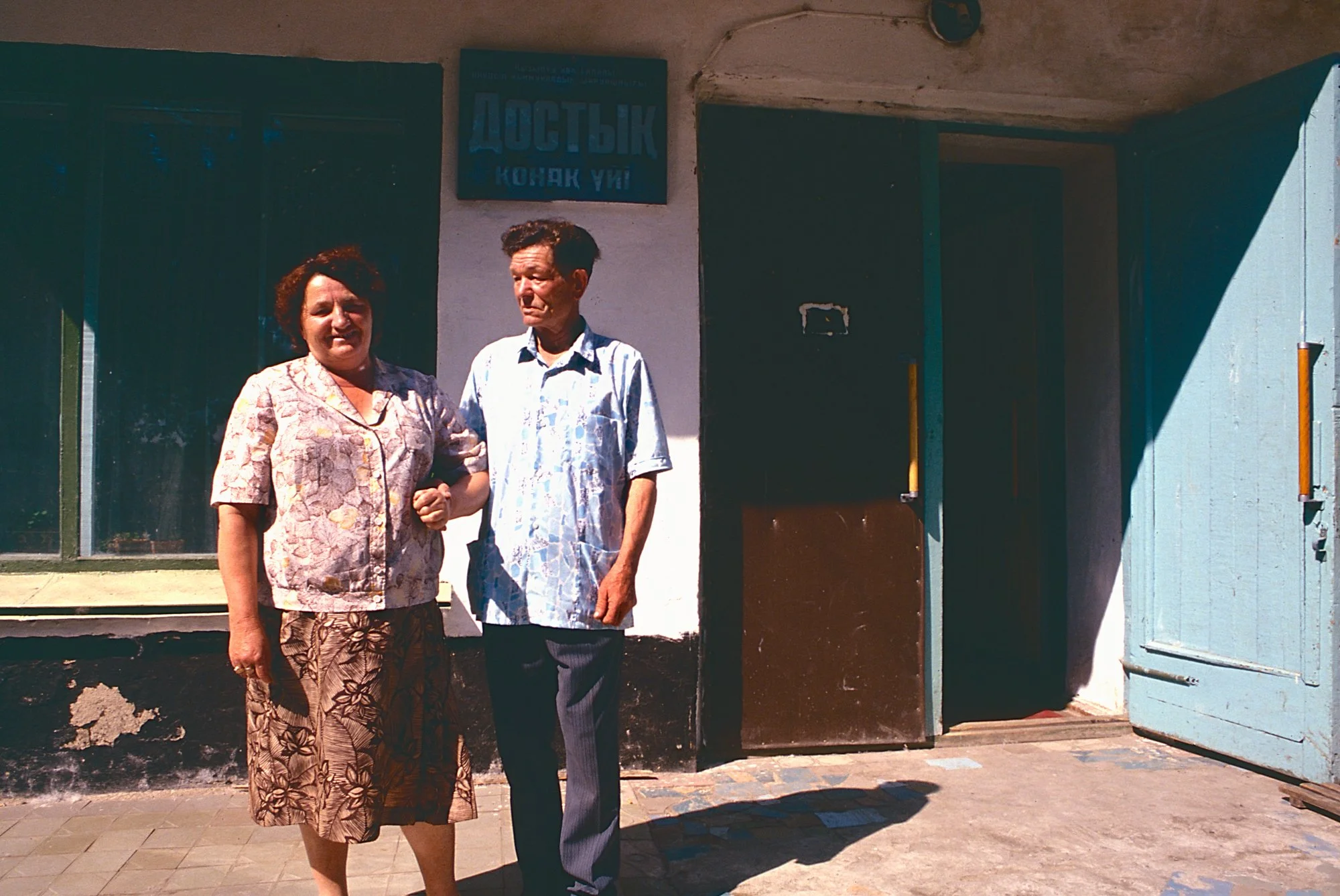 A couple in front of a store.