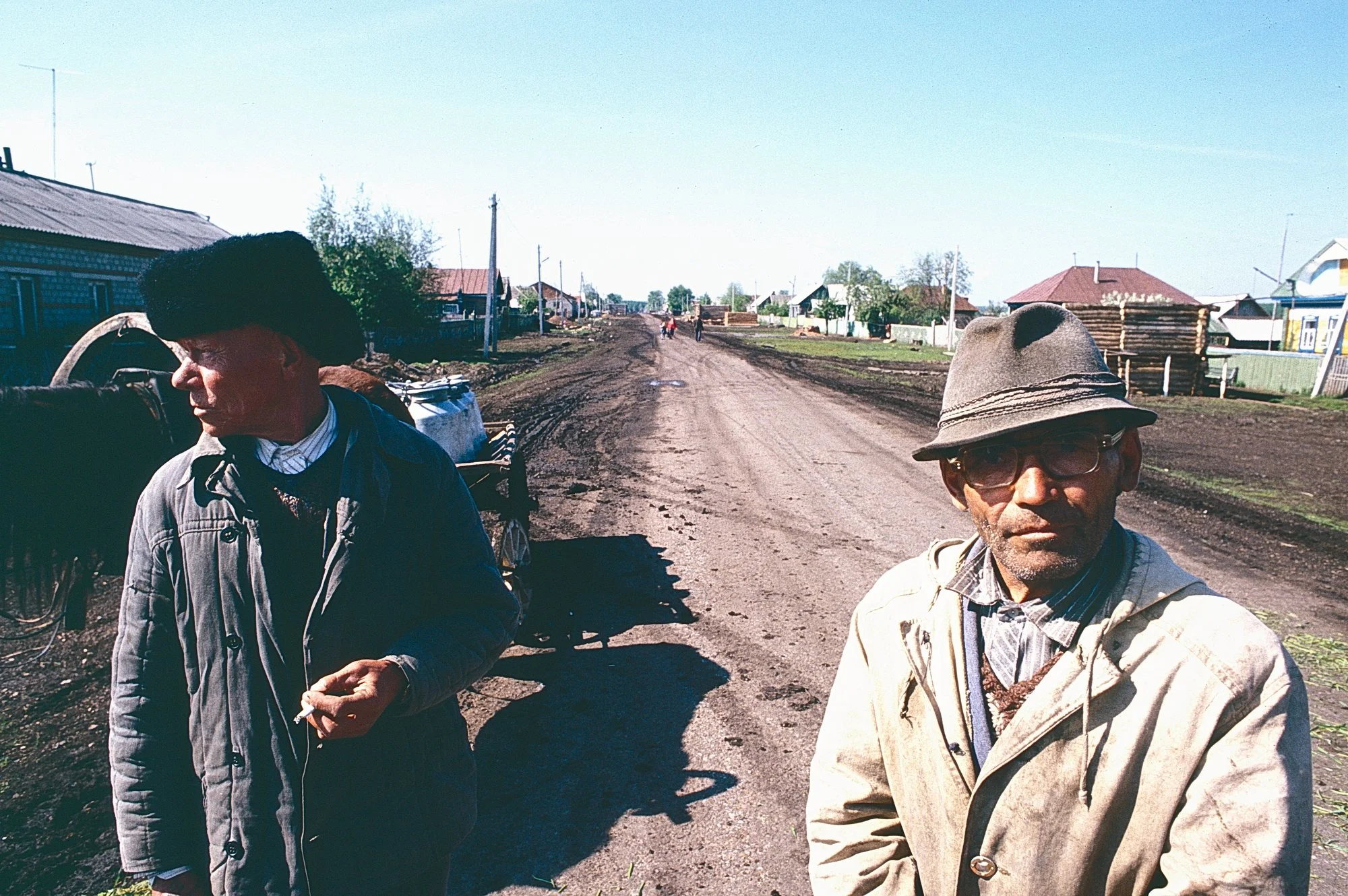 Tatar farmers with their horse drawn cart wait for the collective farm's milk truck in the Russian plains.