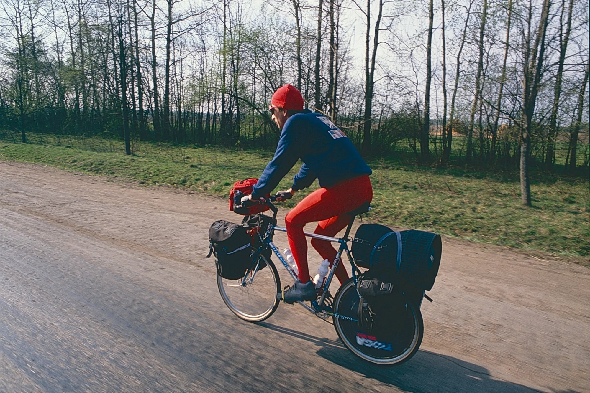 Simon pedaling a still very clean bike as we leave Leningrad behind and enter the Russian countryside.