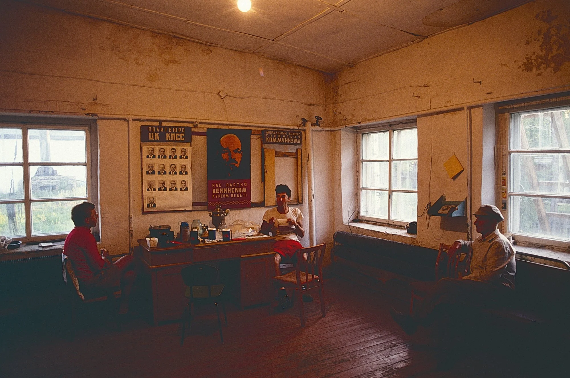 Dinner with Lenin. A local keeps an eye on us as we end the day in a  village where the chief of the local Communist Parry opened the community room for us to spend the night.