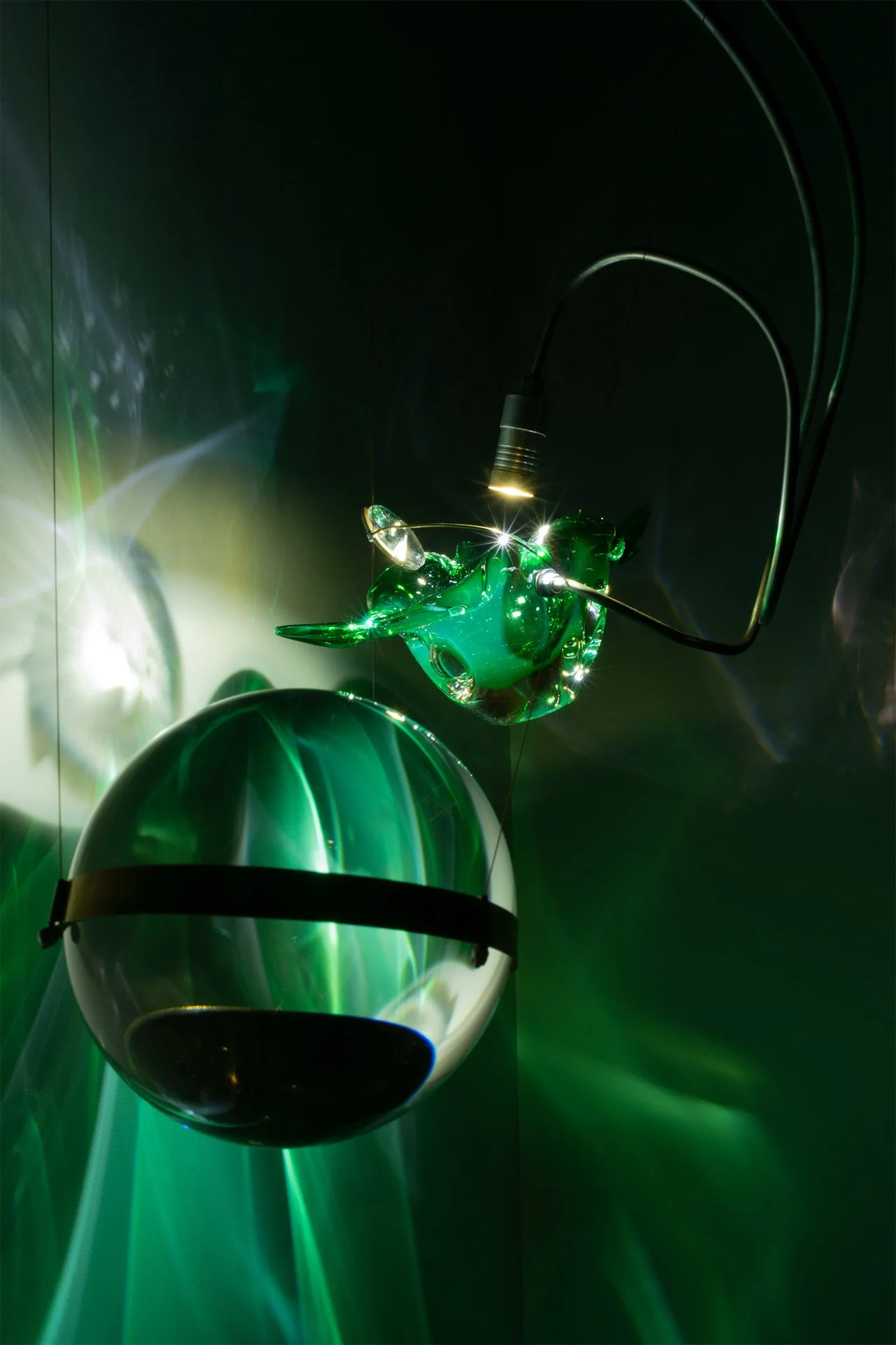 Illuminated detail shot of the bowl and sphere, highlighting the quality of the glass that leads to a unique light cast.