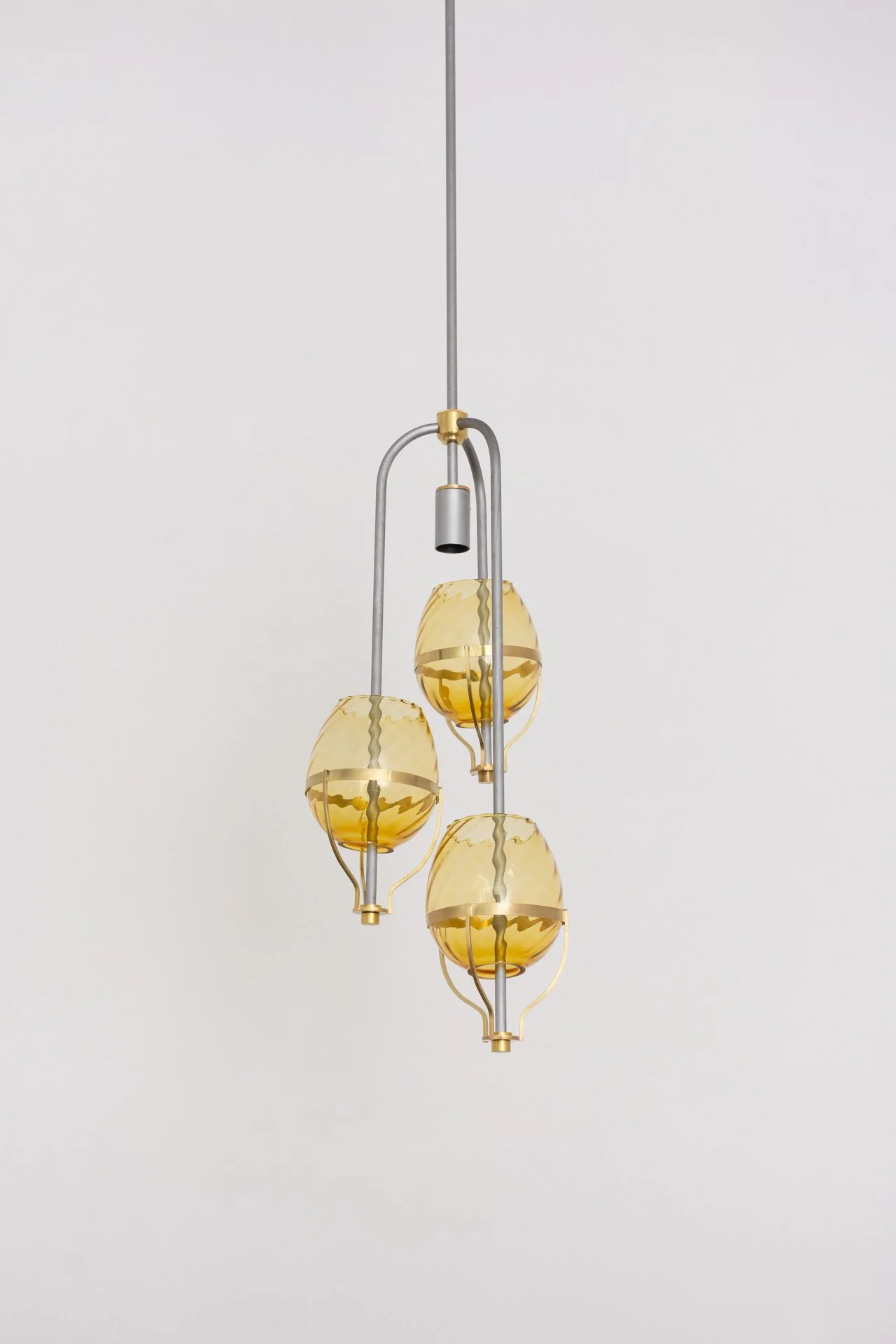 Unilluminated, the three yellow lampshades are emphasized.