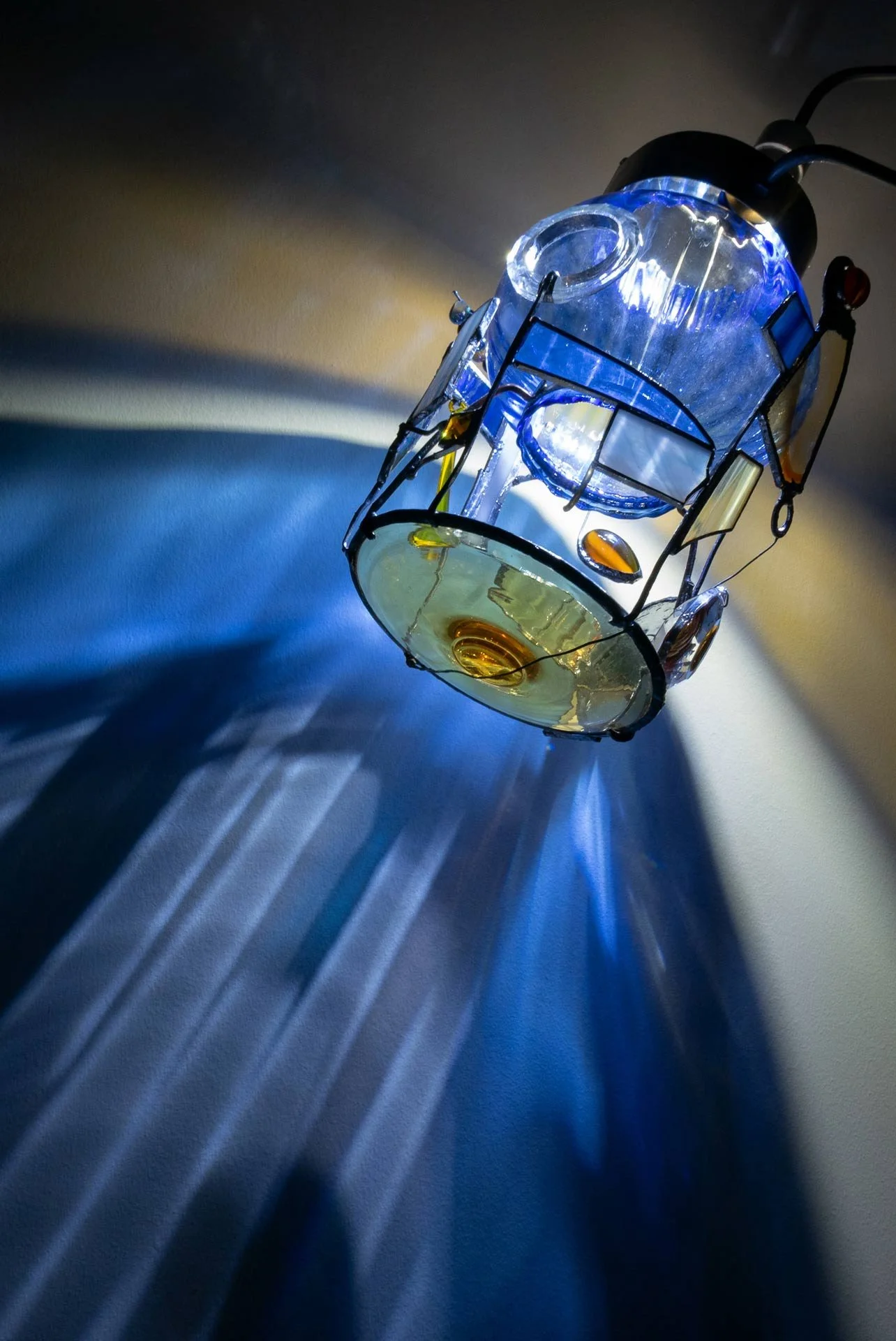 Illuminated detail shot of the lampshade and collaged details, highlighting the quality of the glass that leads to a unique light cast.