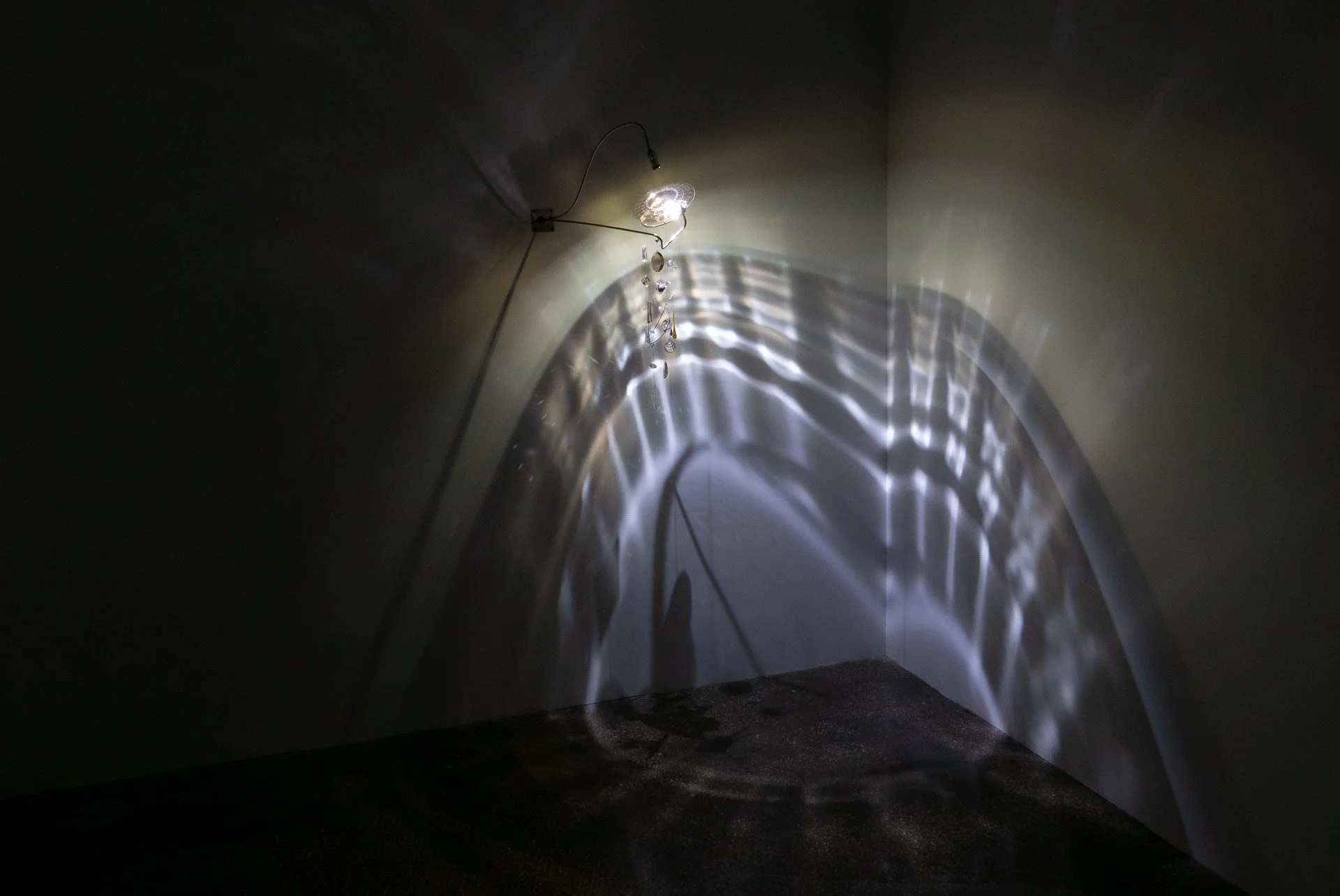 Illuminated, wider view of the fixture displays white light in a faceted pattern.
