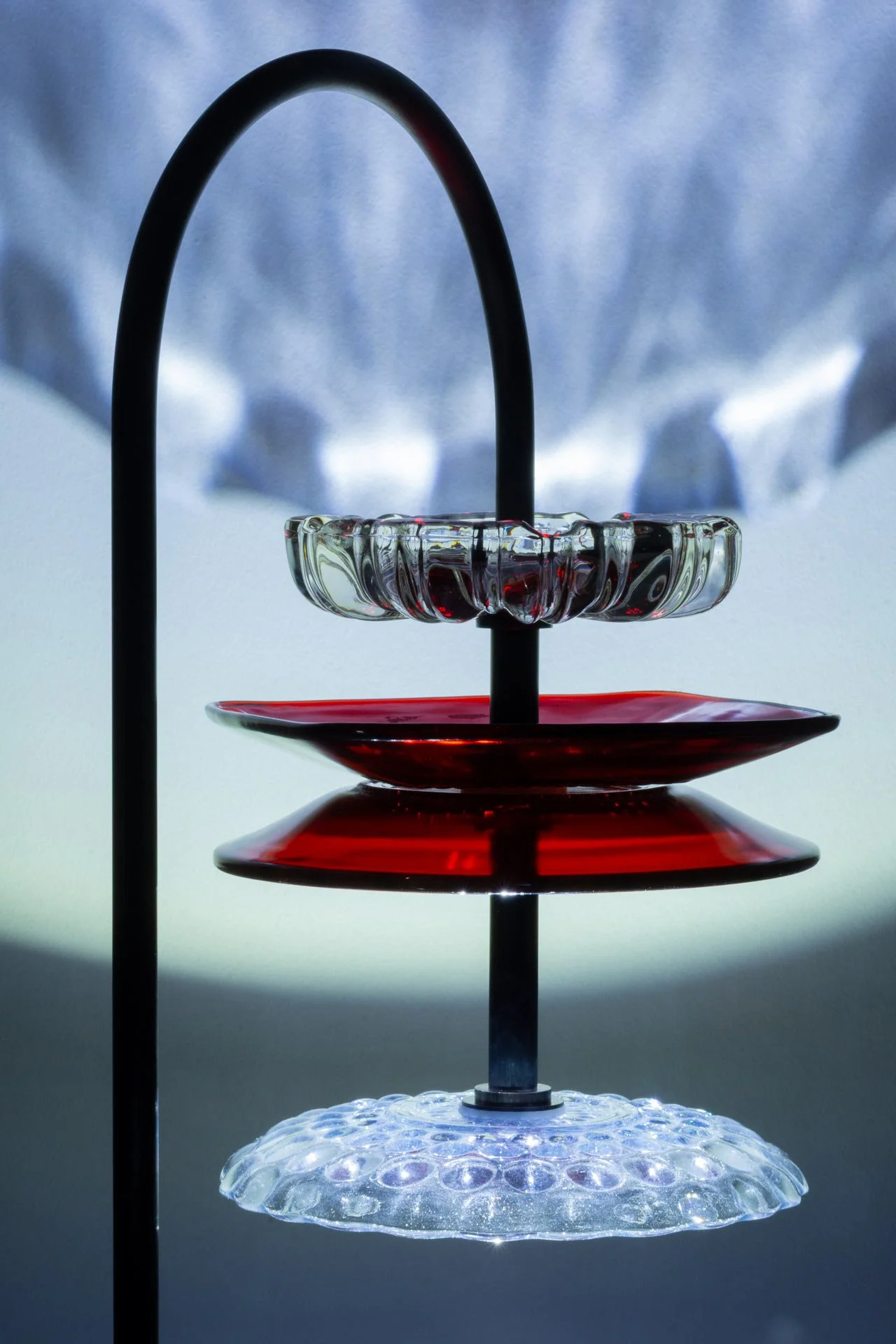 Illuminated detail shot of the plates, highlighting the quality of the glass that leads to a unique light cast.