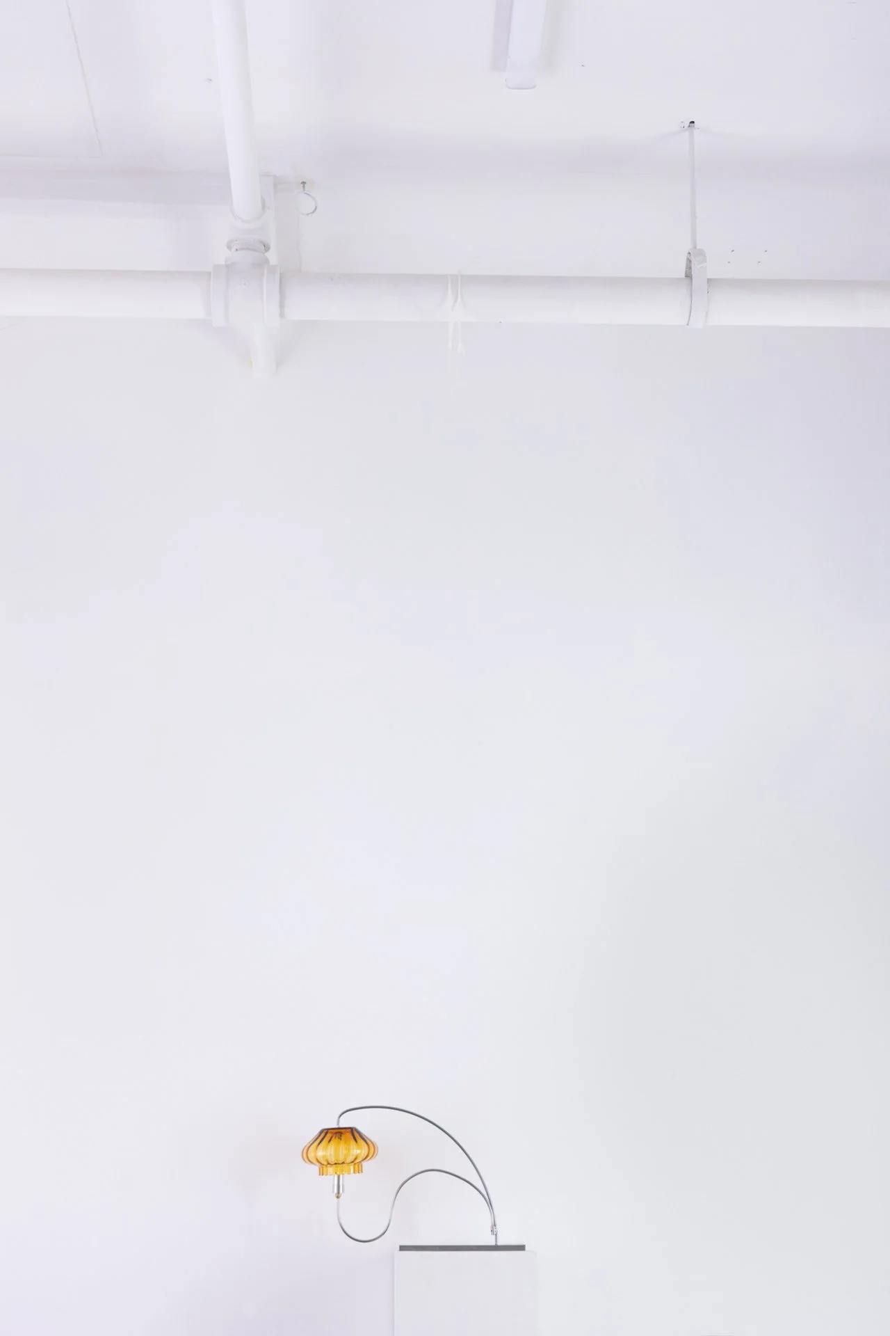 Unilluminated, wider view of the lamp.