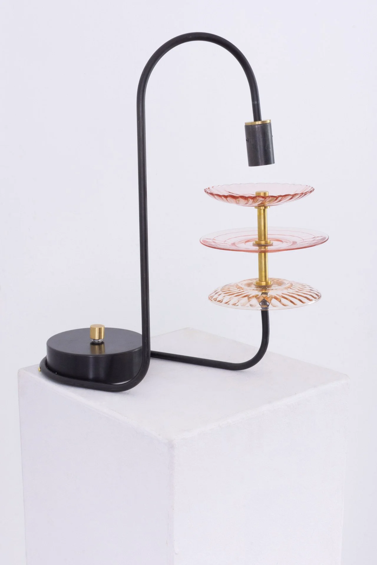 Unilluminated, the pink depression glass plates are emphasized.