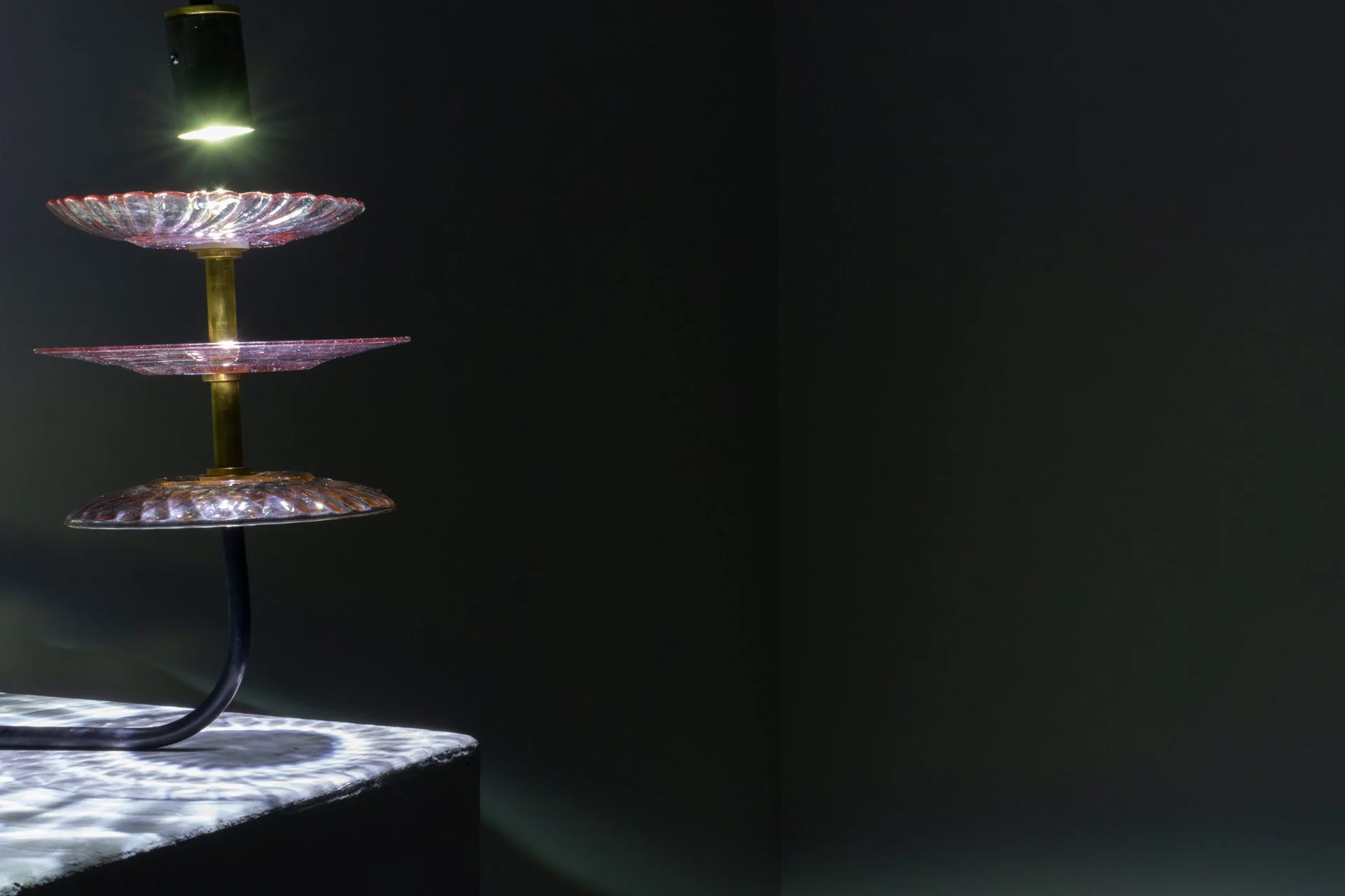 Illuminated detail shot of the plates, highlighting the quality of the glass that leads to a unique light cast.
