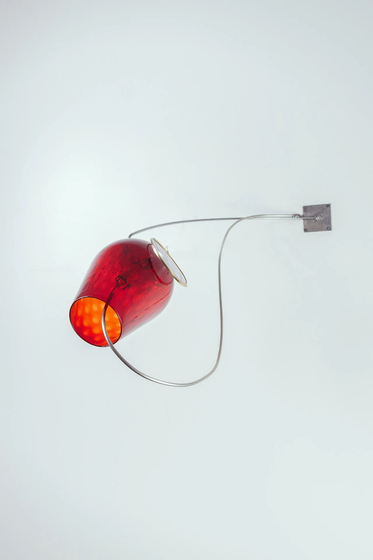 Unilluminated, the red Empoli vase is emphasized.