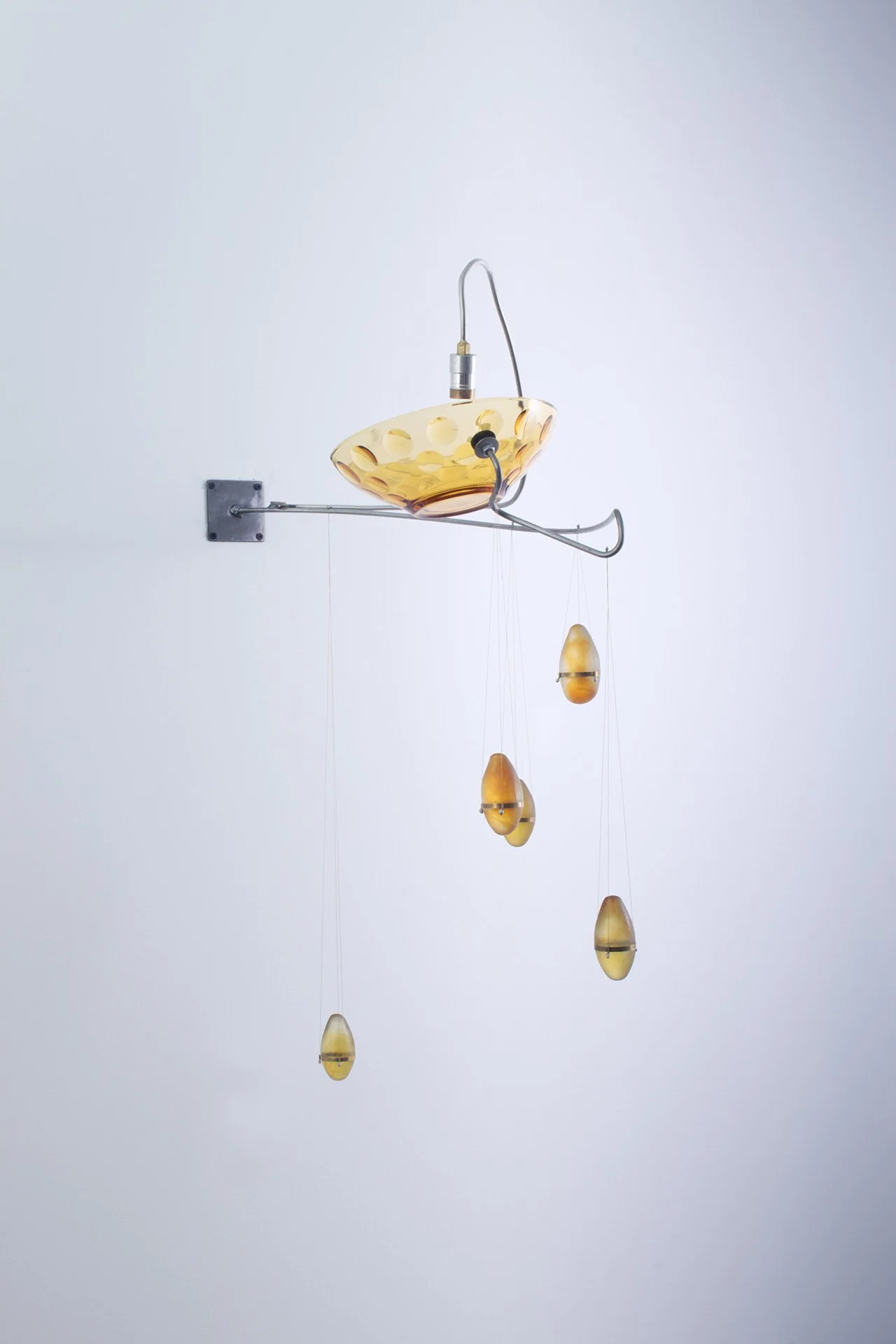 Unilluminated, the yellow bowl and five yellow fishing weights are emphasized.
