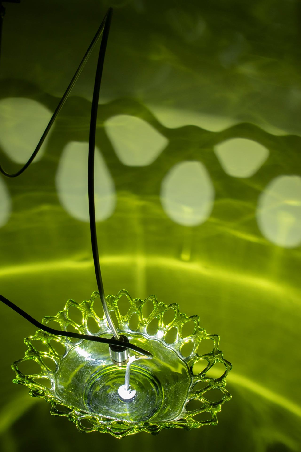 Illuminated detail shot of the bowl, highlighting the quality of the glass that leads to a unique light cast.