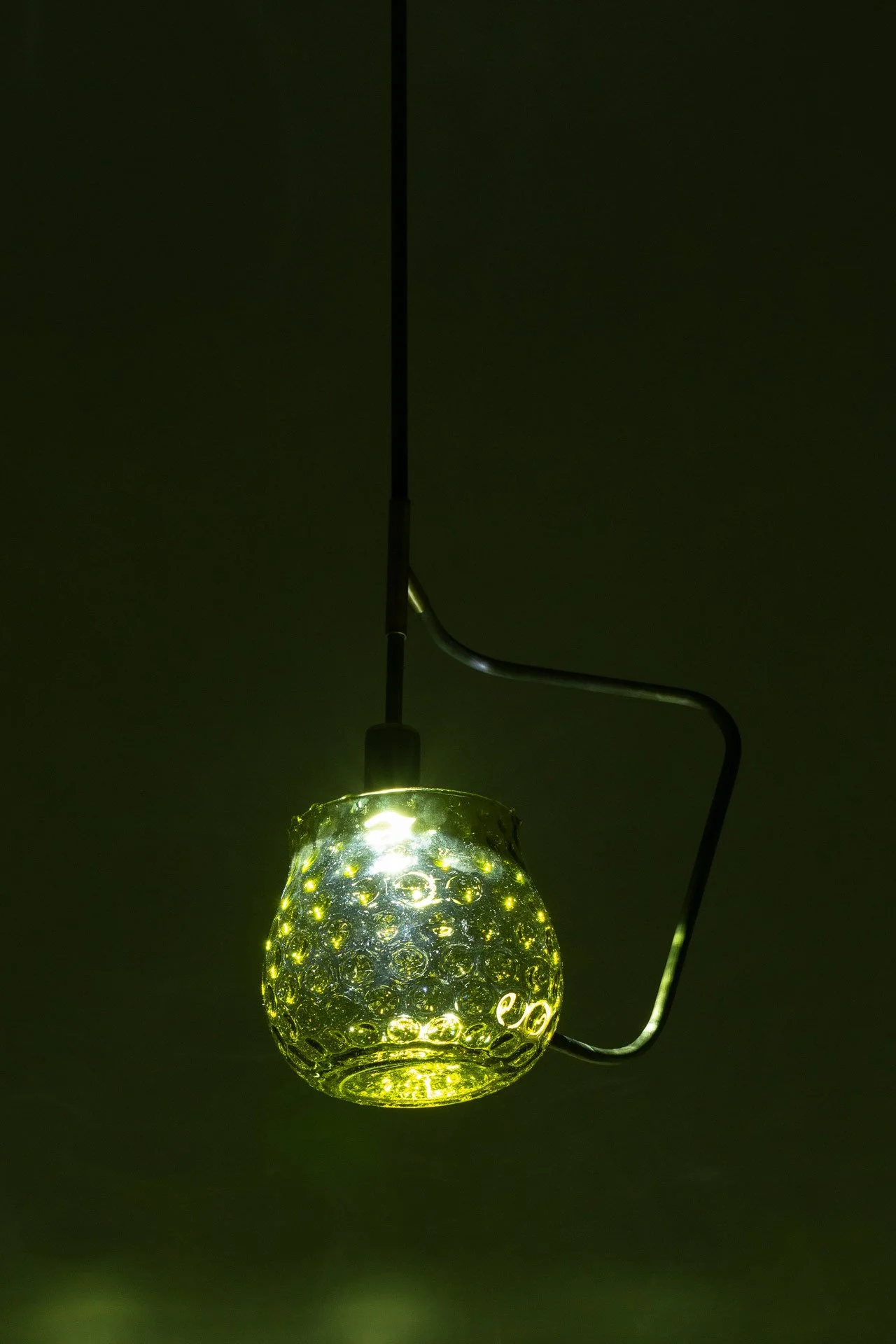 Illuminated detail shot of the vase, highlighting the quality of the glass that leads to a unique light cast.