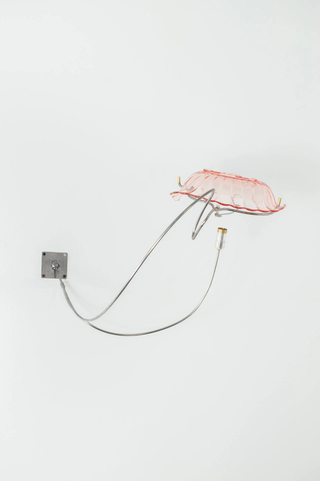 Unilluminated, the pink scalloped glass bowl is emphasized.
