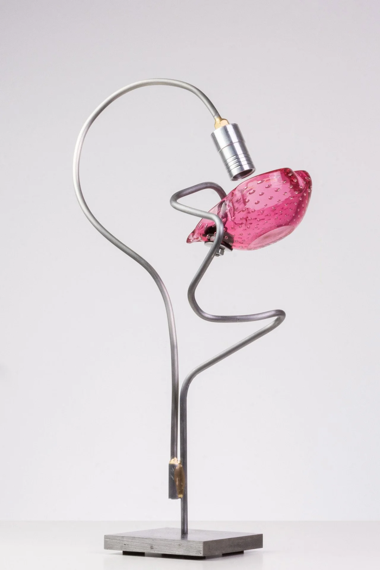 Unilluminated, the pink bullicante ashtray is emphasized.