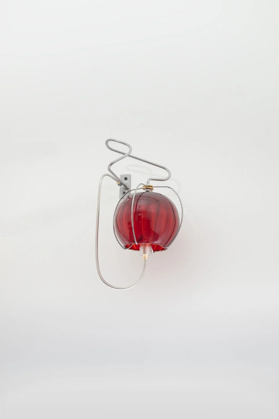 Unilluminated, the red ribbed vase is emphasized.