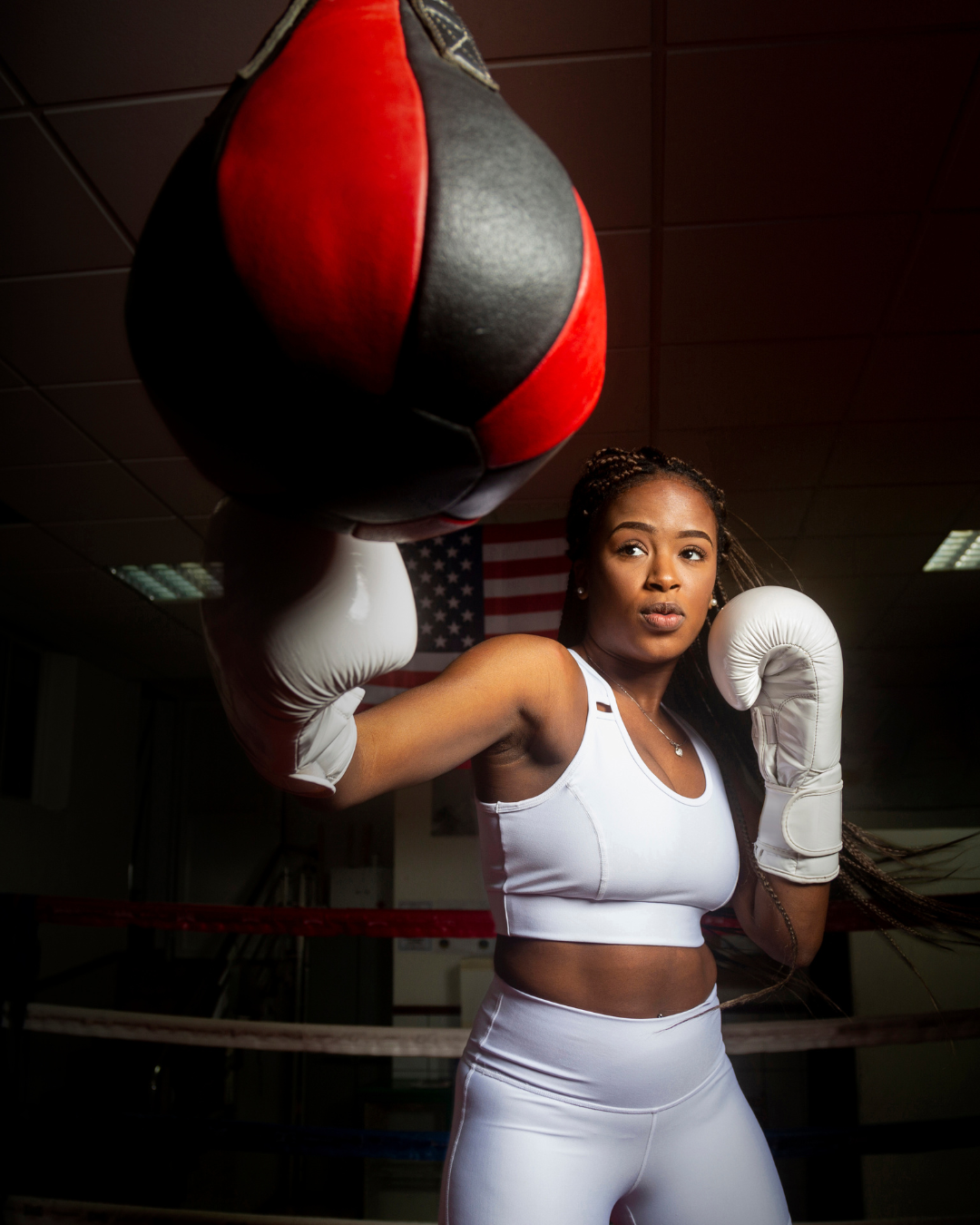 Female boxer training with speed bag at Gleason's boxing gym