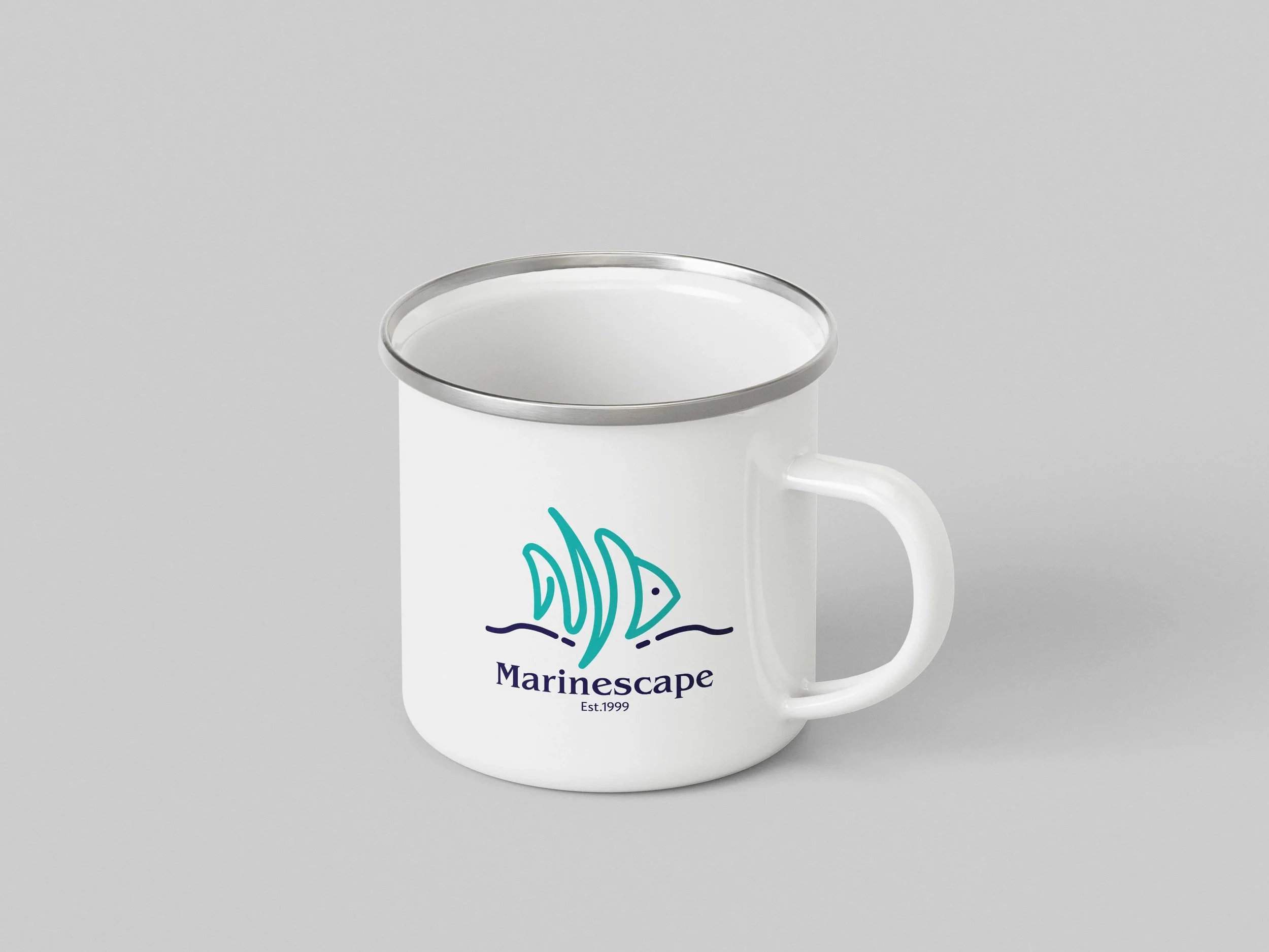 White mug with a marine-themed logo, including a stylized fish and water waves, with the text 'Marinescape Est. 1999'.