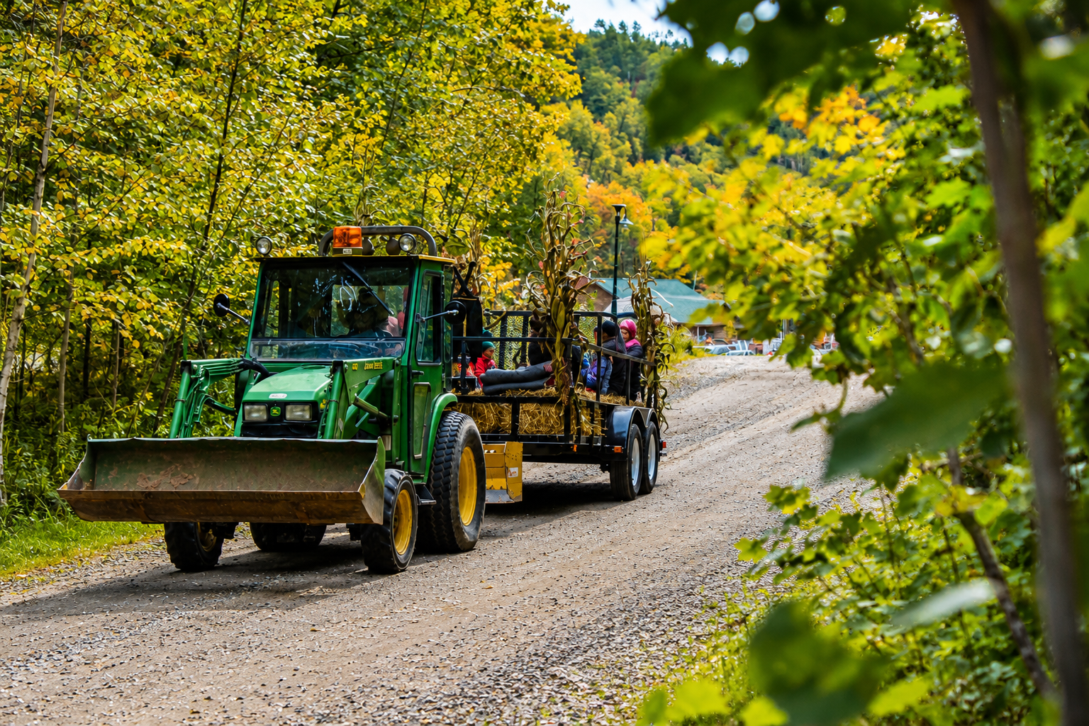 Guests riding a festive hayride through the campground during Harvest Fest celebrations.