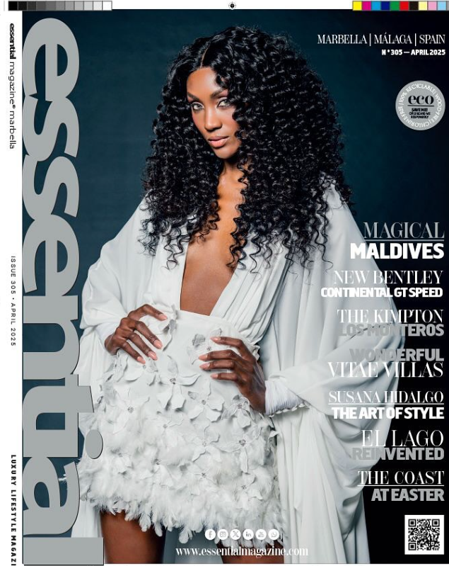 Portada de revista con una mujer de cabello rizado y vestimenta blanca, posando con confianza. Texto en la portada menciona destinos turísticos como Maldivas, Malasia y España, además de artículos sobre autos, estilo de vida y arte.