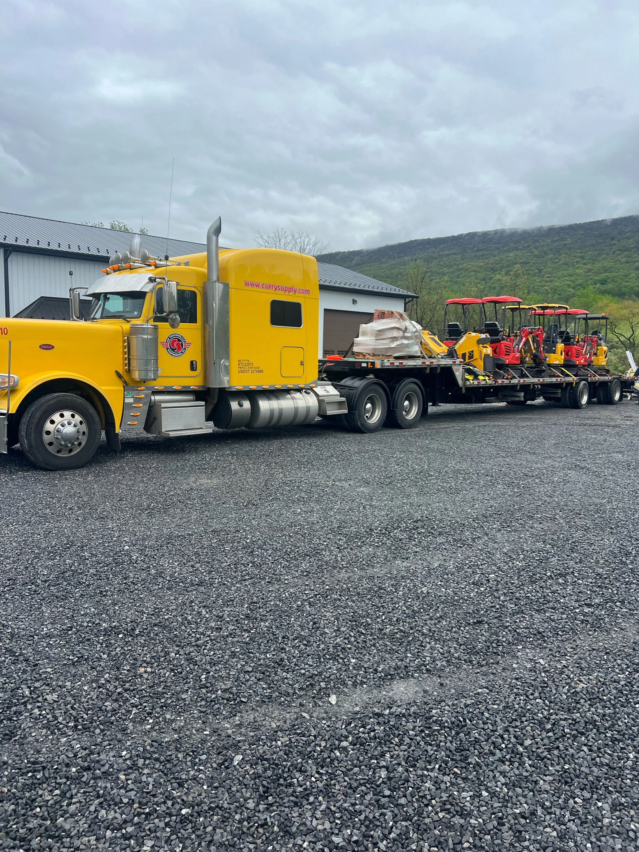 Mini excavators delivered on flatbed truck