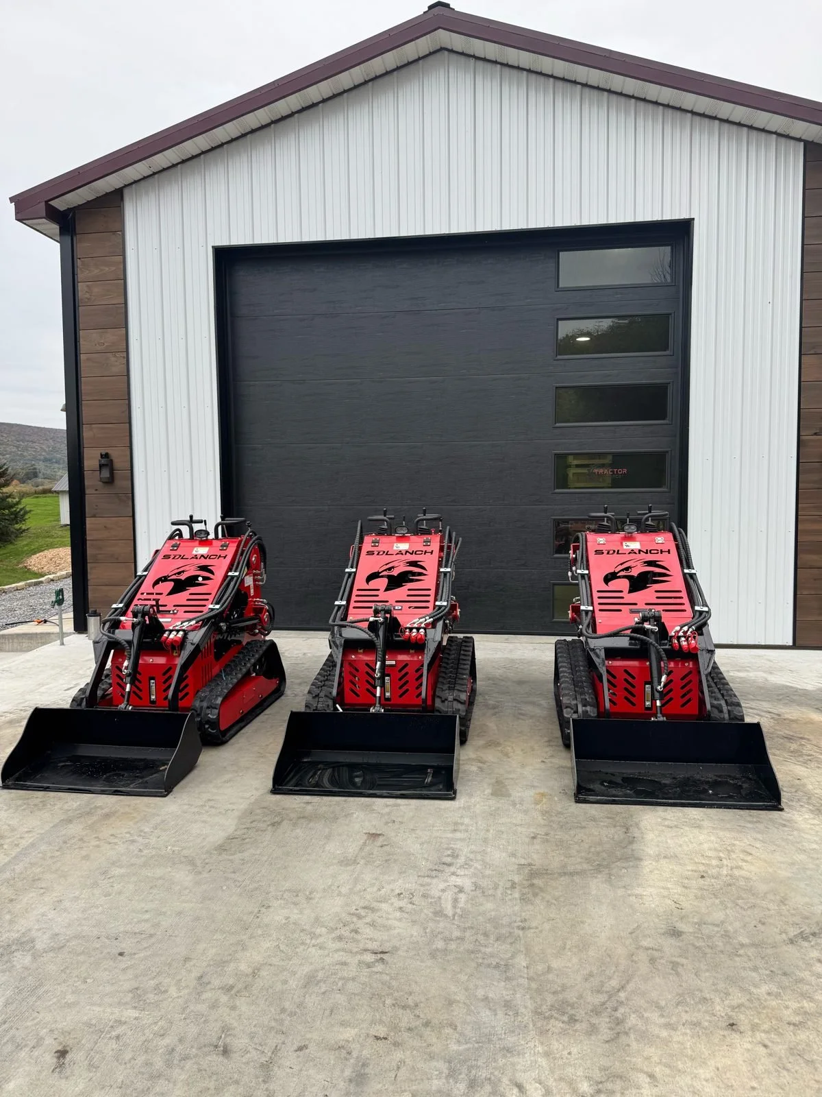 sdlanch-sdll60-stand-on-mini-skid-steer-garage-door-lineup.jpg