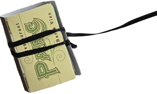 Miniature replica of a pack of Winston cigarettes tied with black strings.