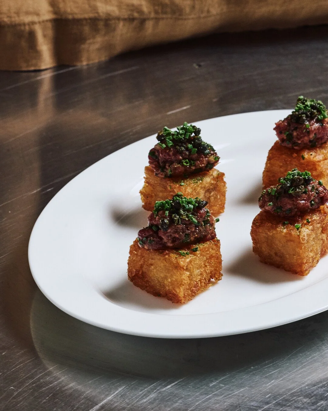 The new season menu is here, and it's giving everything we hoped for. 

Richer flavours, considered pairings, a little quiet drama on every plate. Swipe to see what's coming to your next event.

1. Potato galette square with classic steak tartare, fr