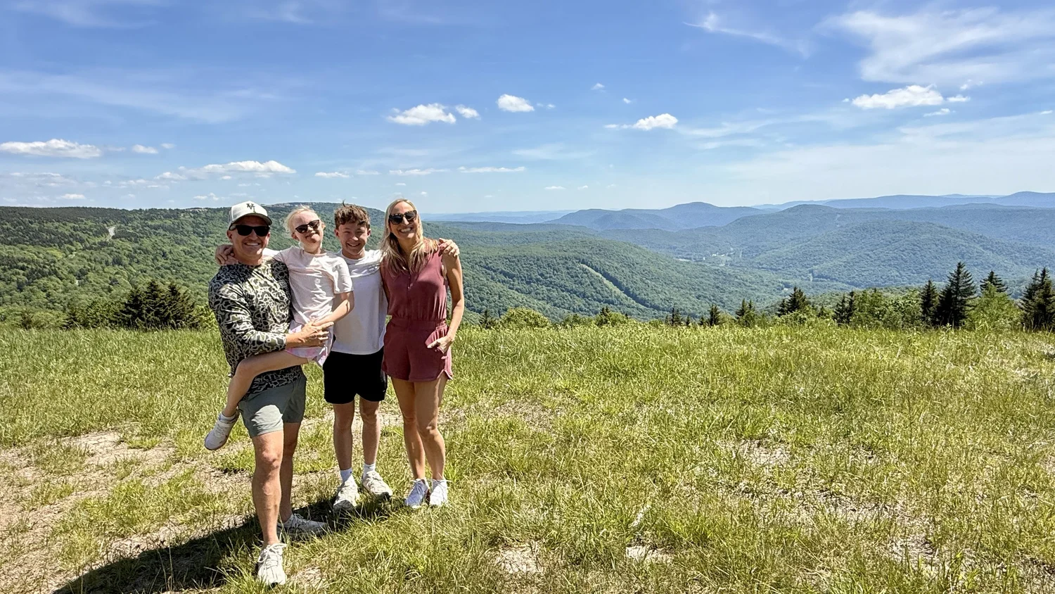 Jordan Becnel with his wife, son, and daughter on a mountain overlook