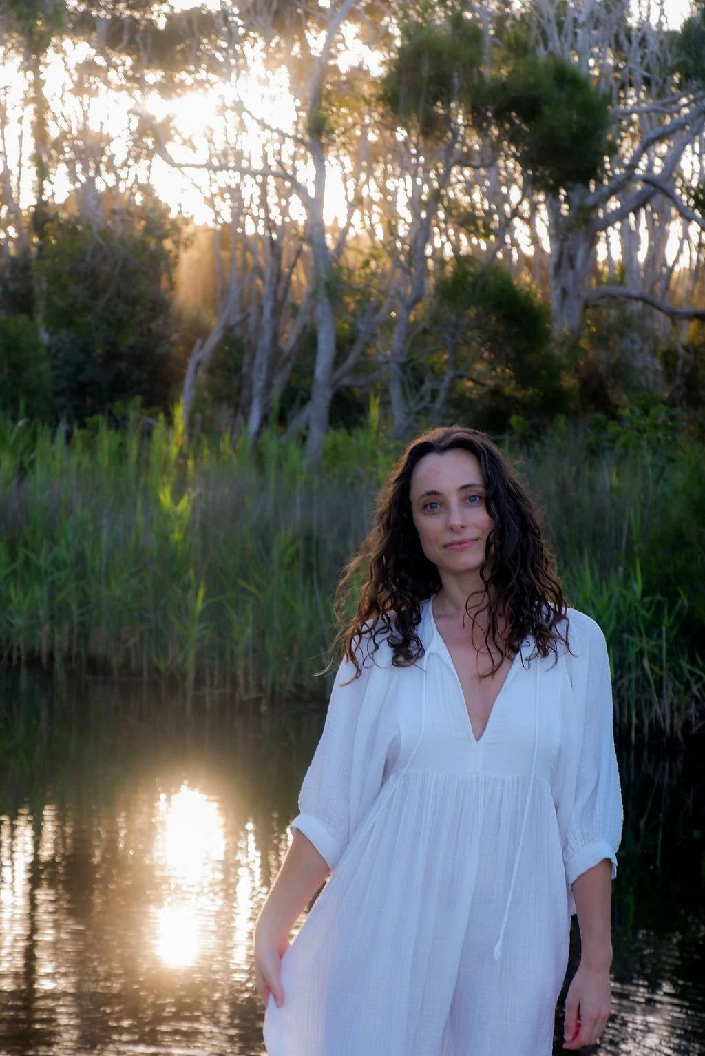 Portrait of PSYCH-K® facilitator standing in a lake in natural light