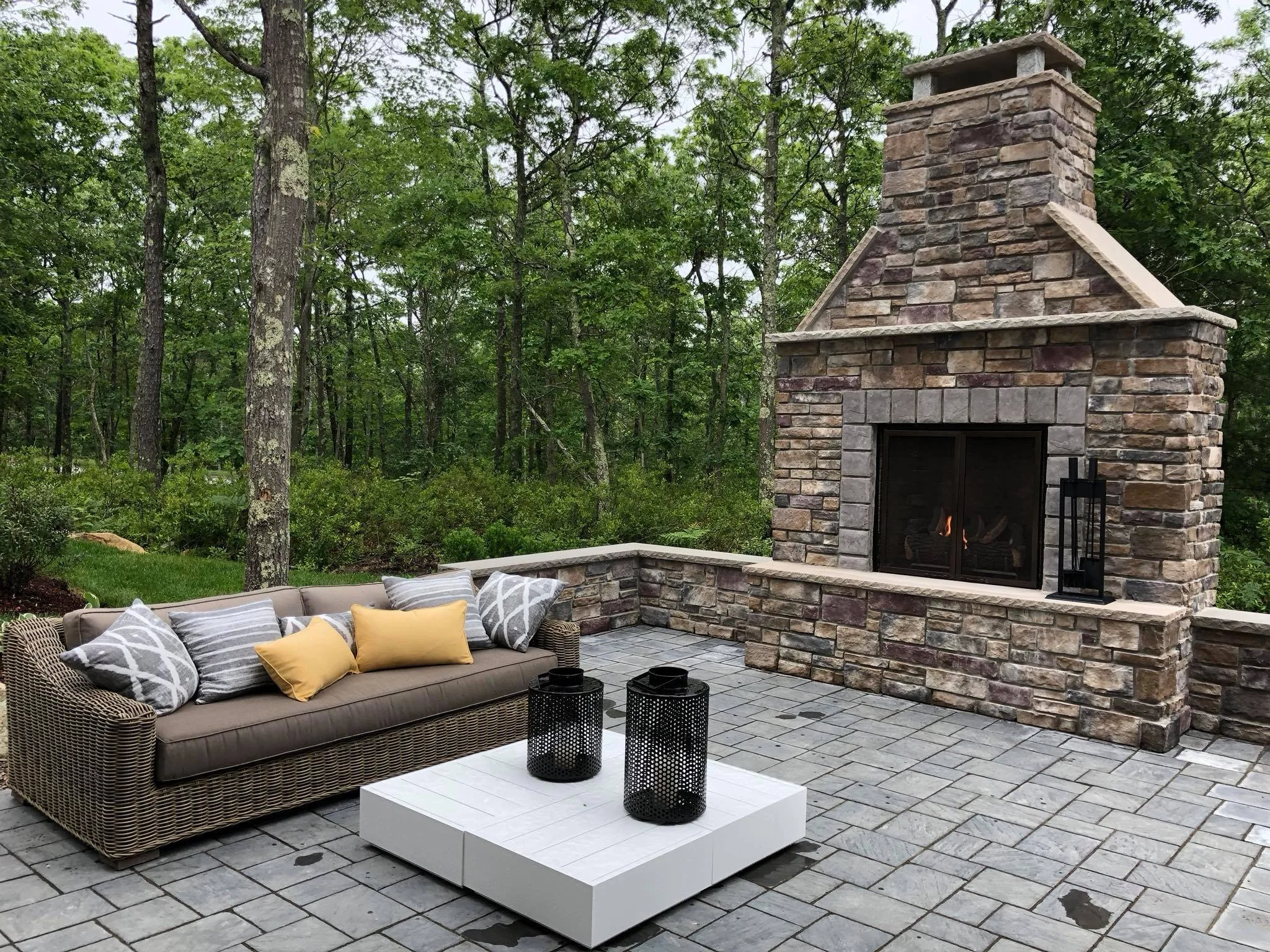 Outdoor stone fireplace and paver patio