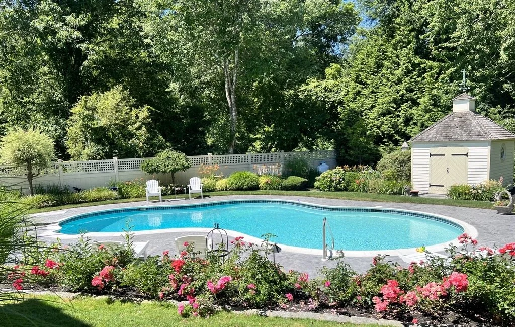 In-ground pool and pretty garden with pink flowers